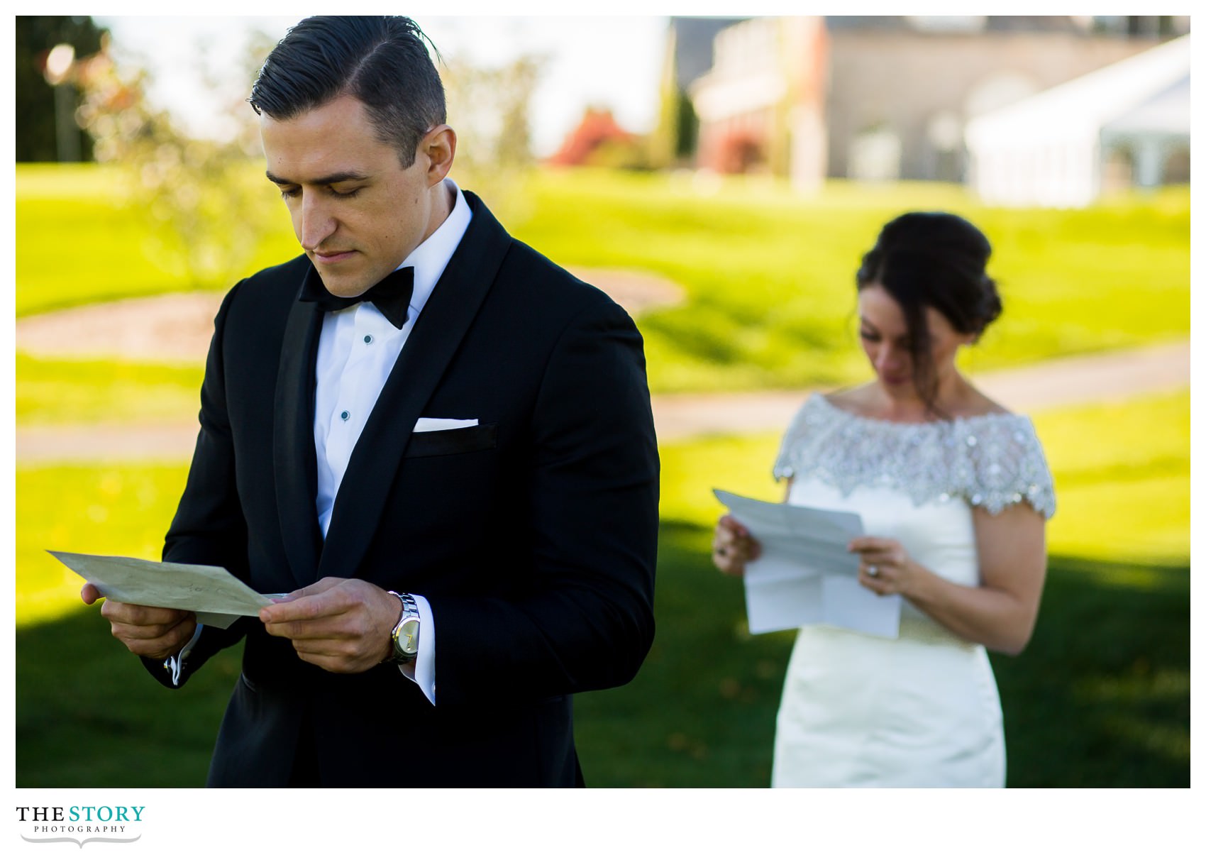 bride and groom read notes from each other before wedding day first look