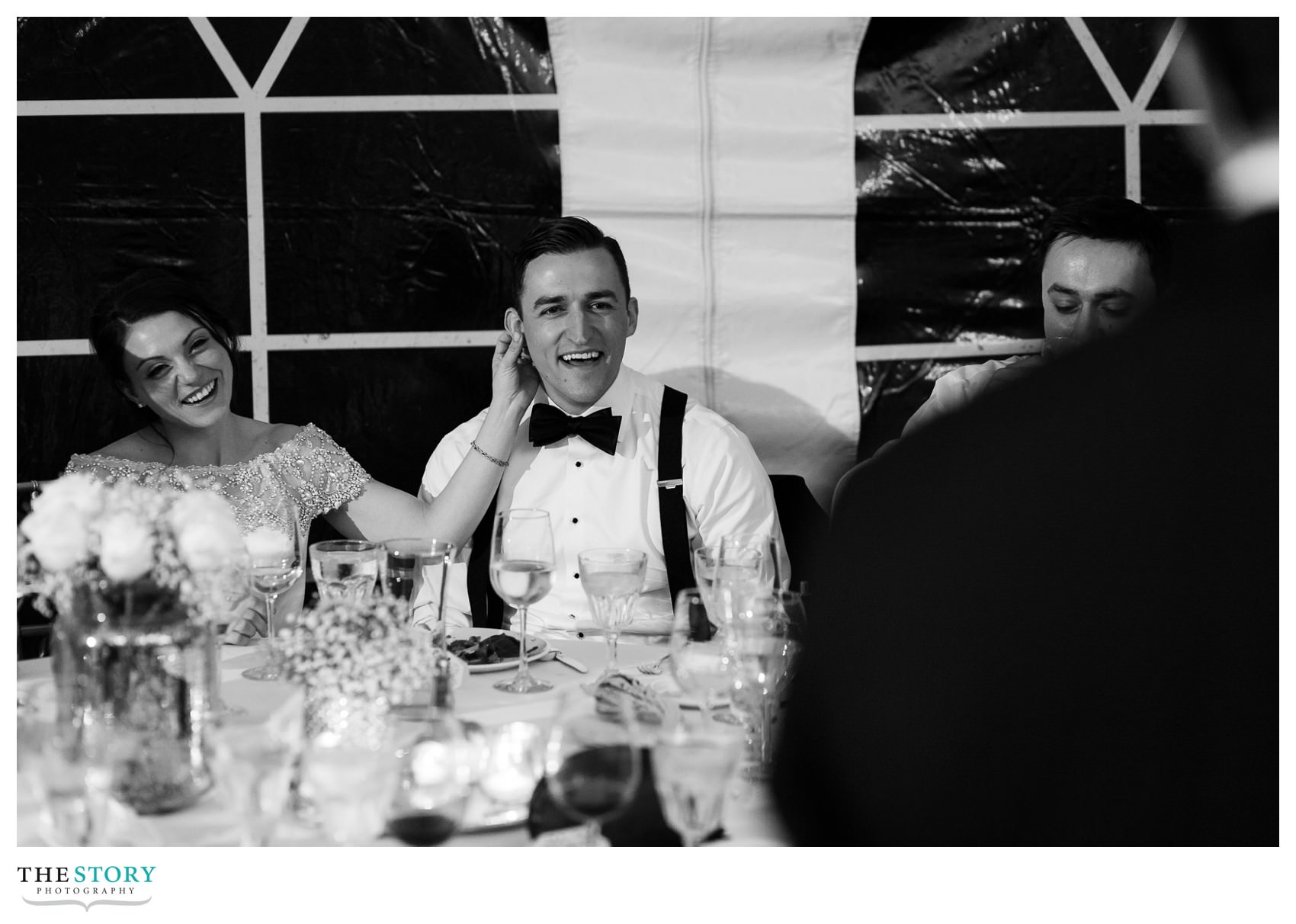 bride and groom listen to best man speech