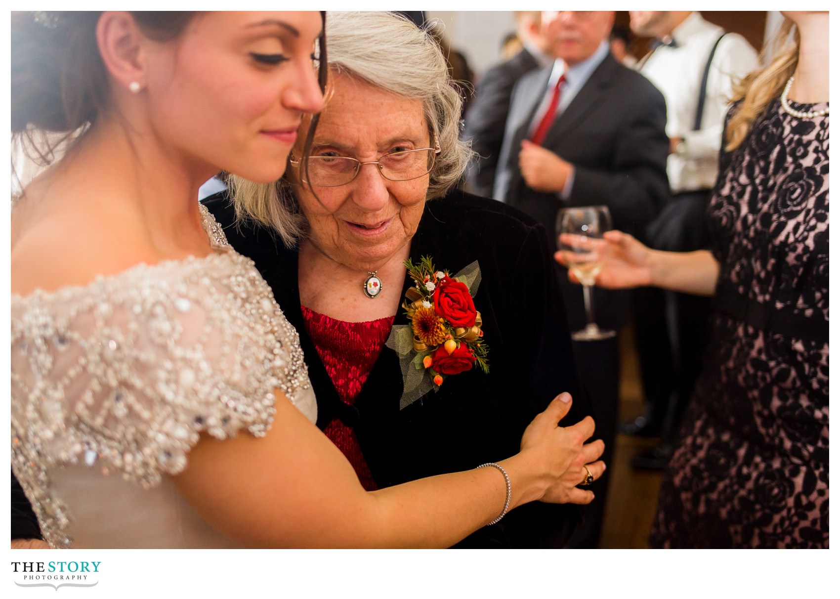 bride hugs grandmother during reception at Onondaga Country Club