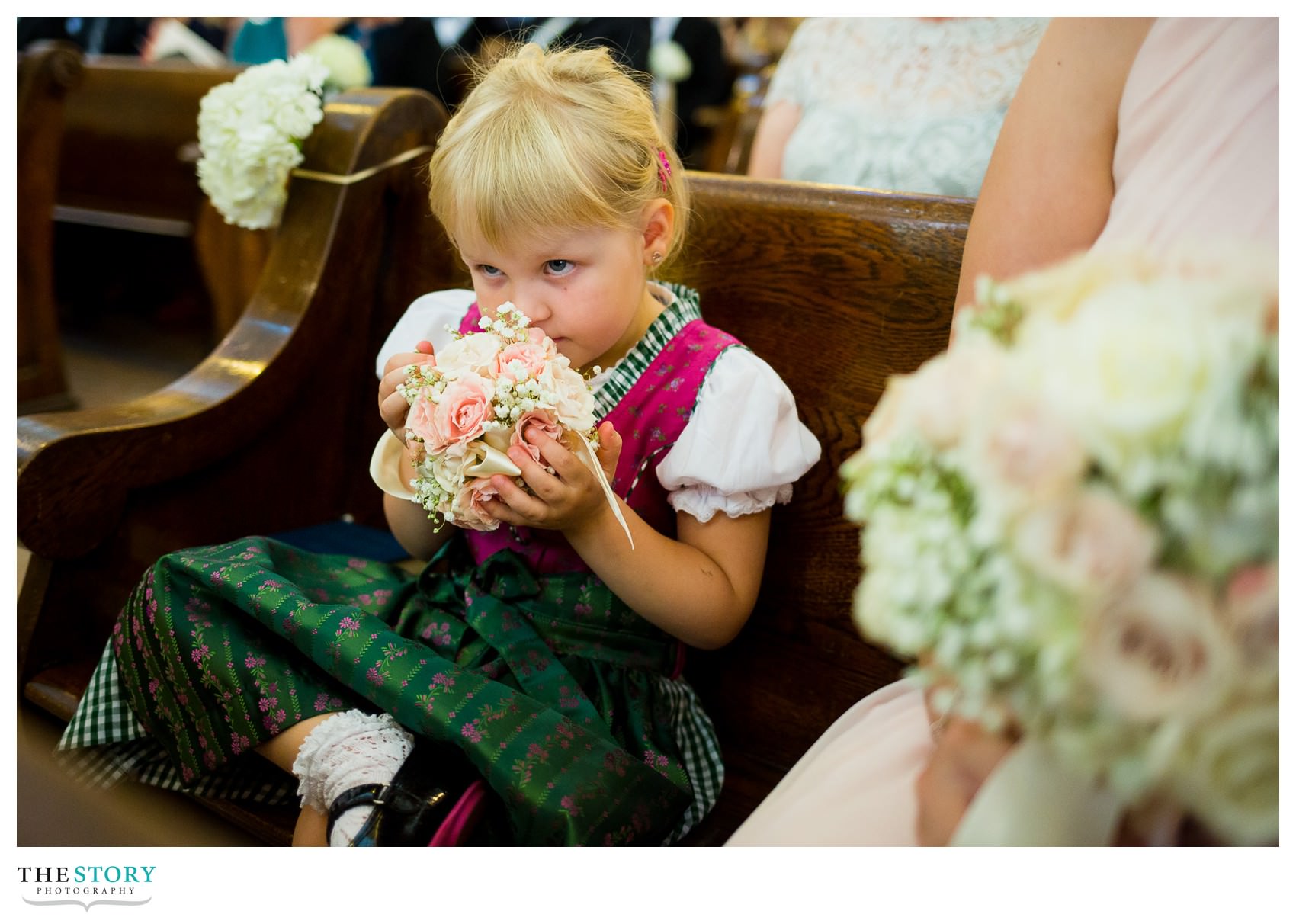 flower girl enjoying her flowers during wedding ceremony