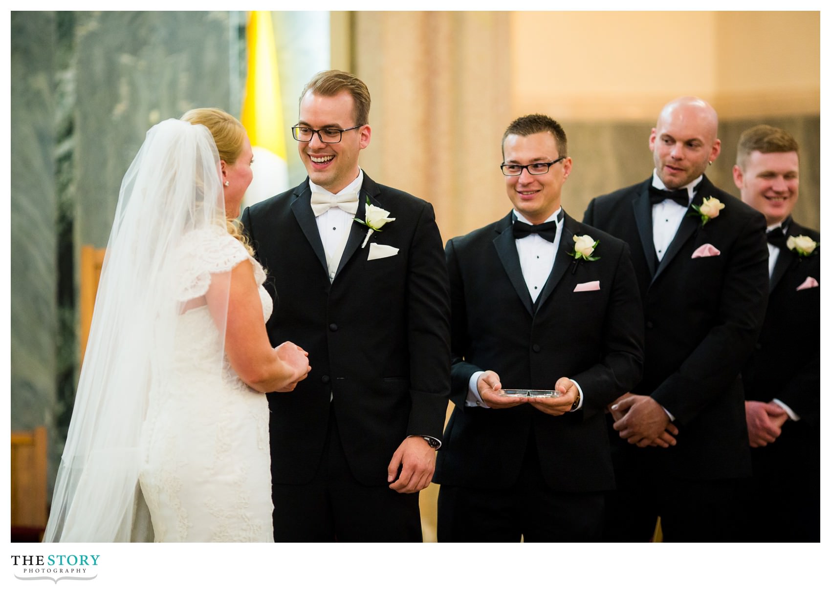 groom enjoying wedding ceremony at Sacred Heart in Syracuse