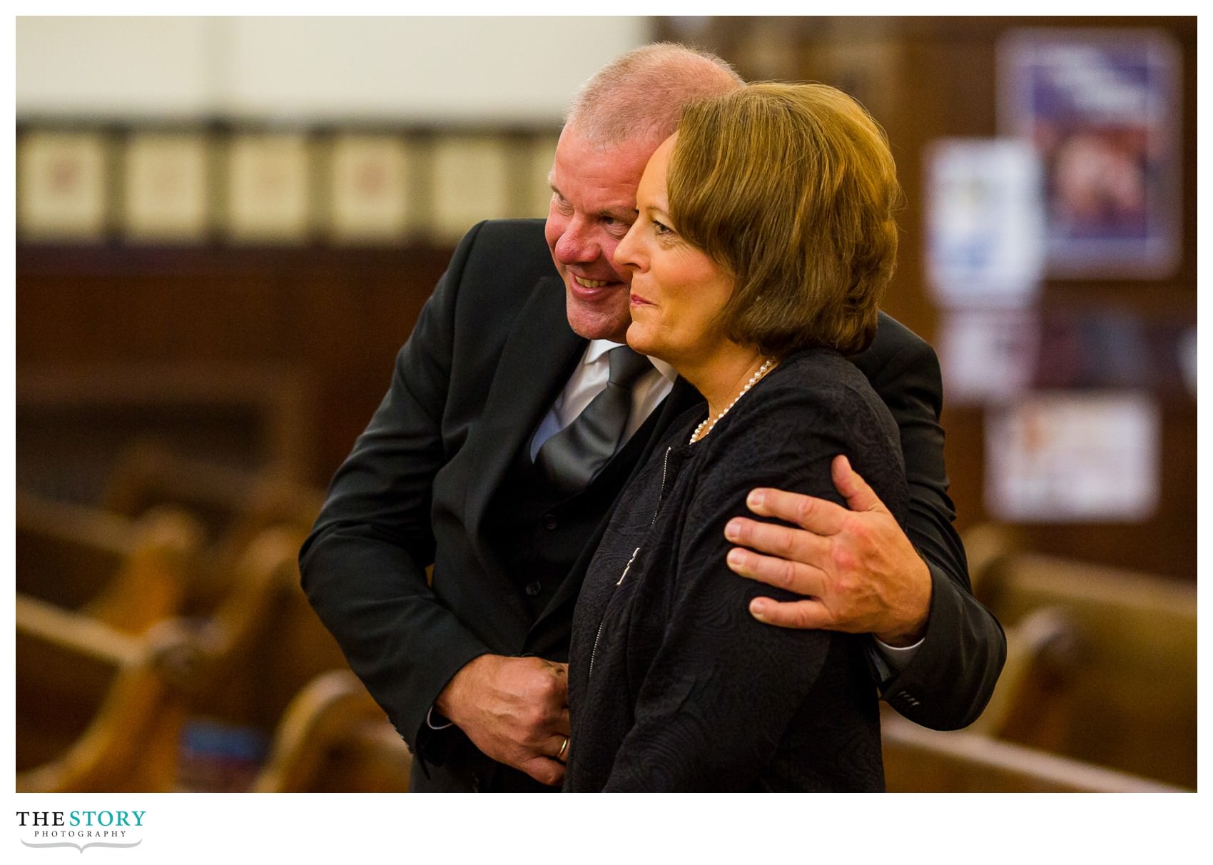 groom's parents enjoy a moment during syracuse wedding ceremony