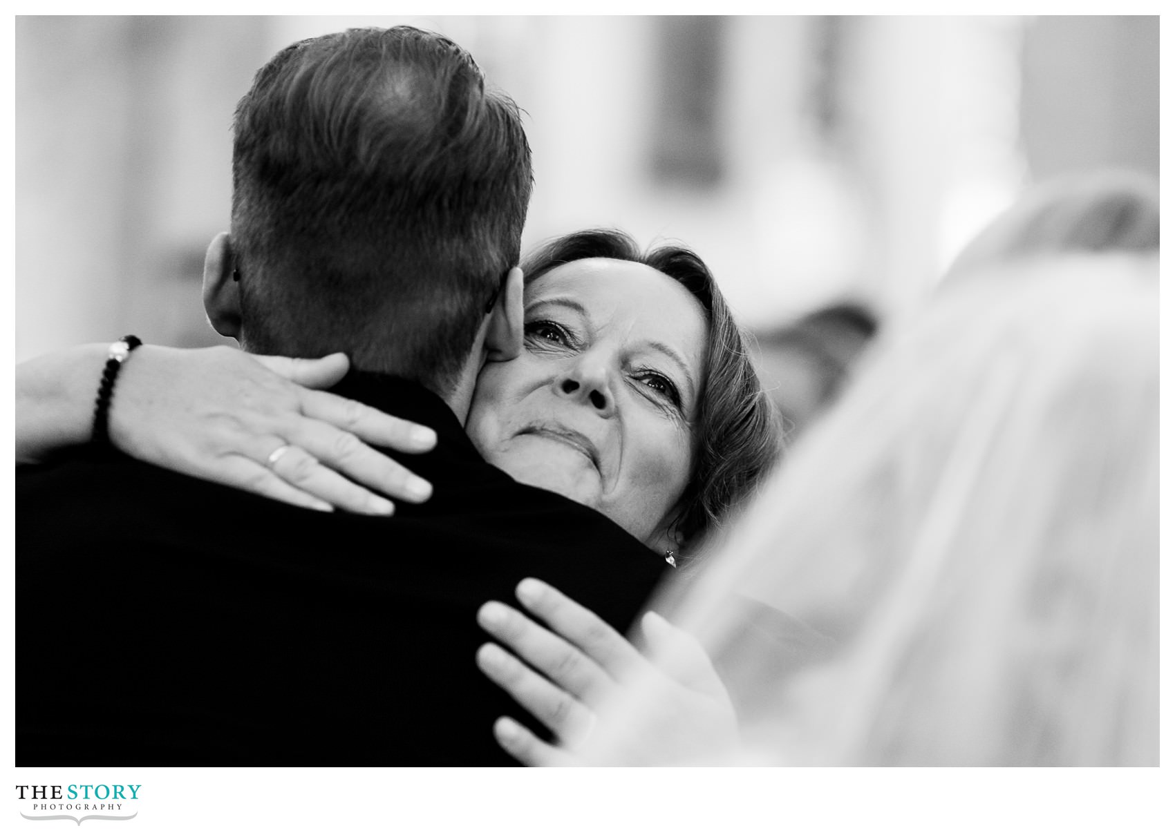 groom and mother hug during Syracuse wedding ceremony