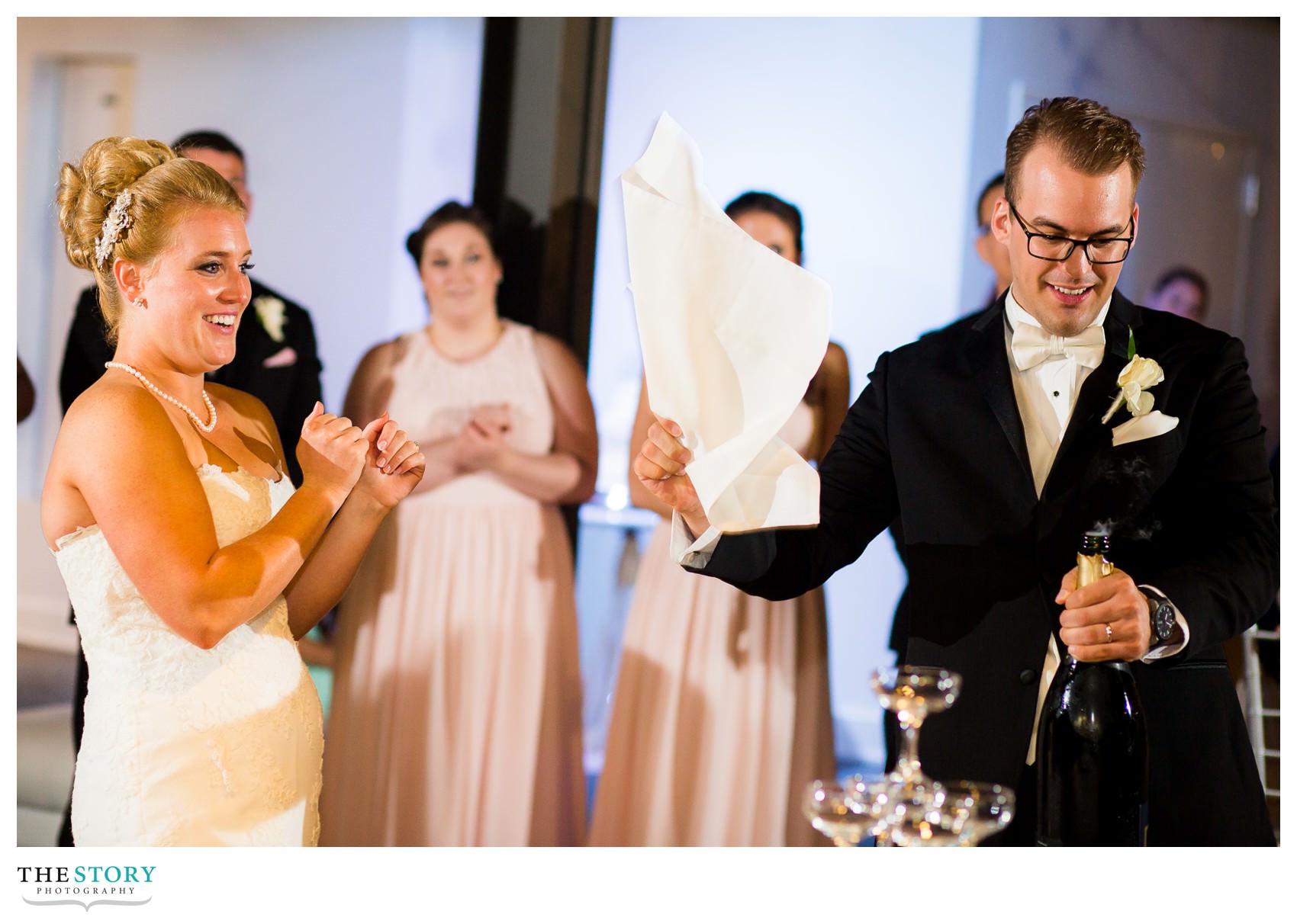 Groom opens bottle of champagne at Sky Armory wedding reception