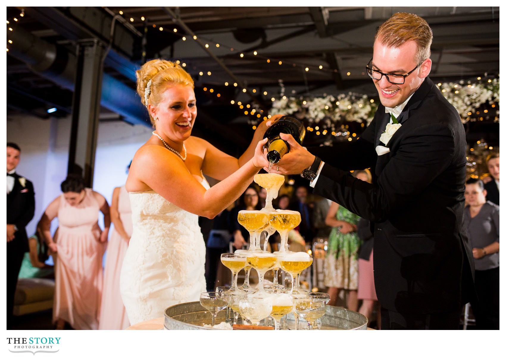 bride and groom pour champagne at Sky Armory wedding