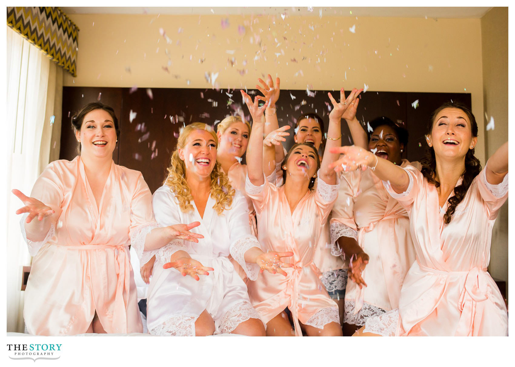 bridesmaids throwing confetti at Jefferson Clinton Hotel Syracuse