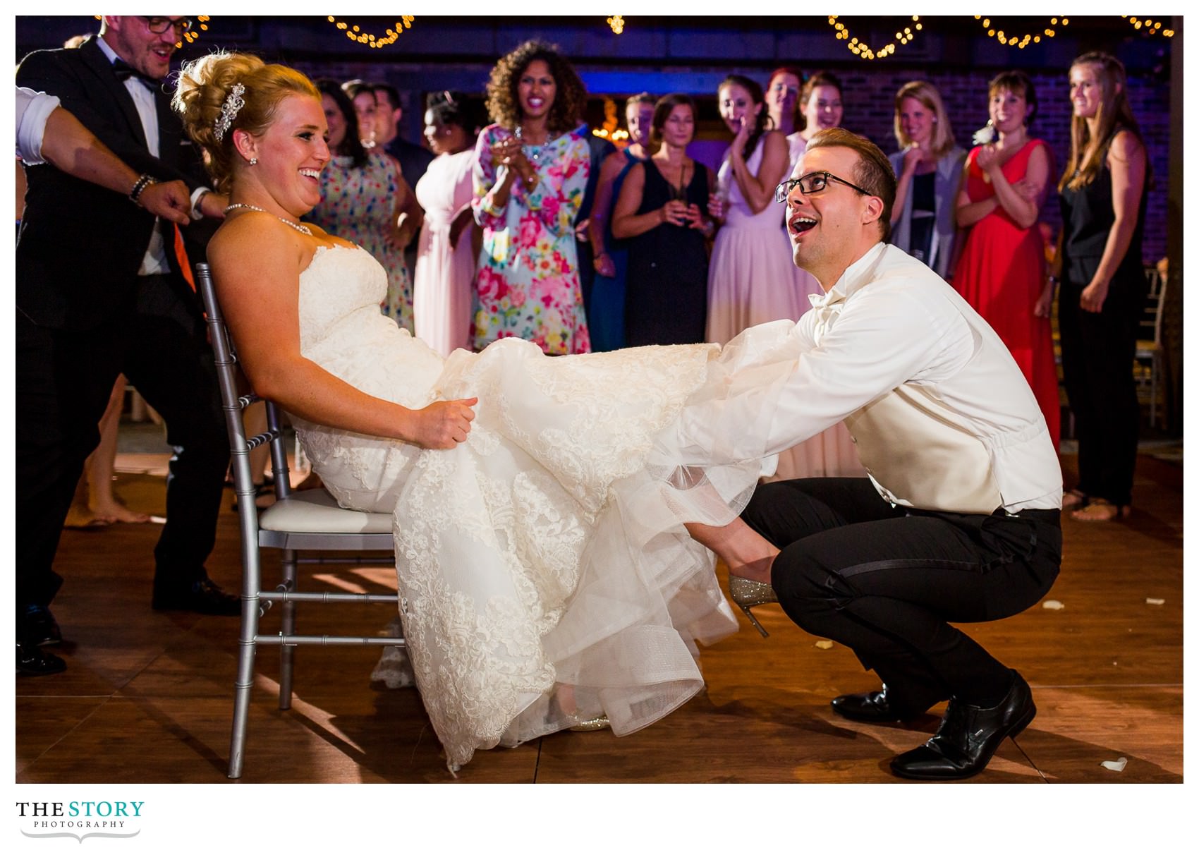 groom takes off bride's garter at wedding reception