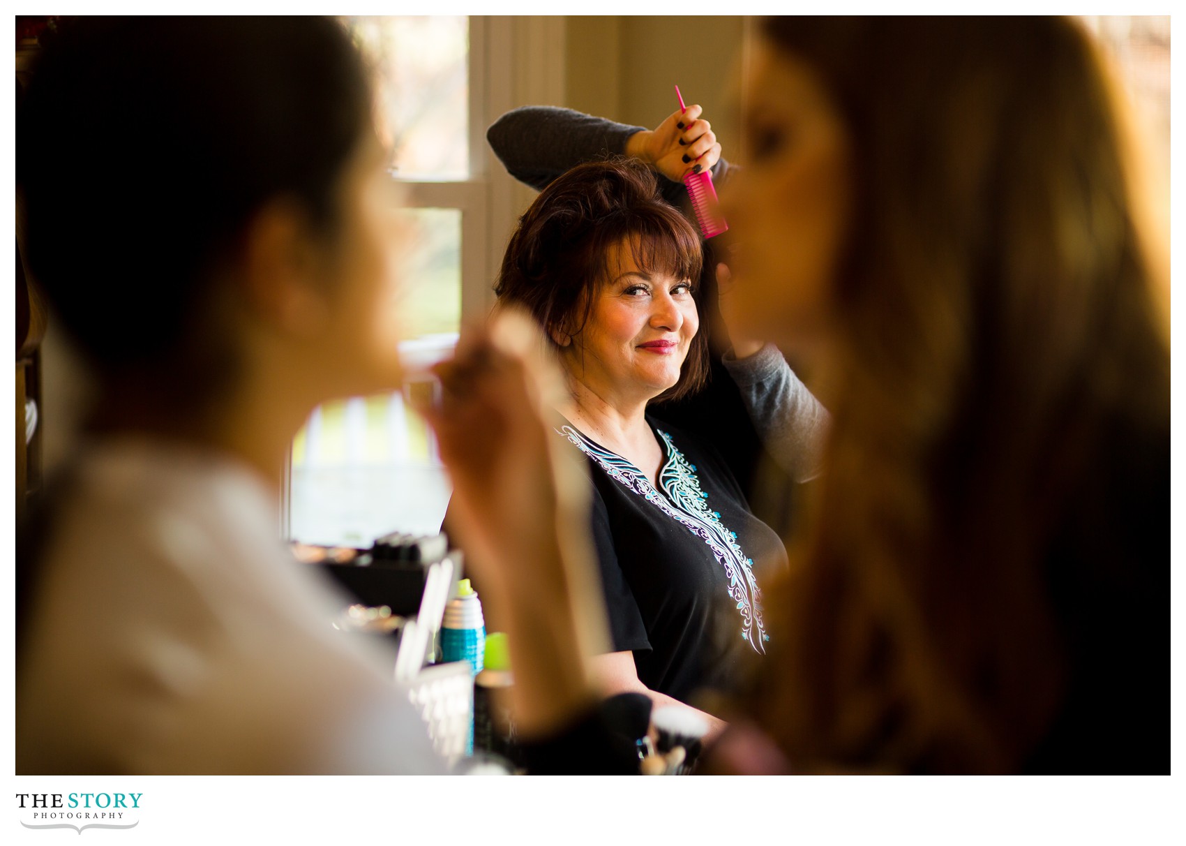 bride's mother looking at bride getting ready