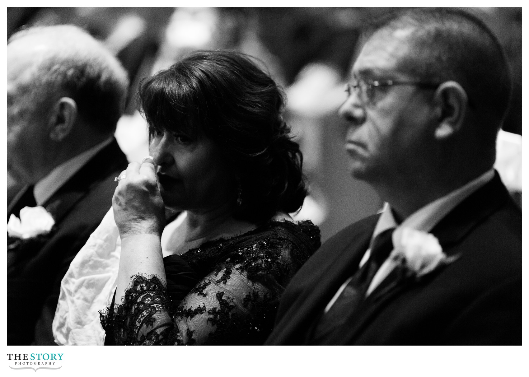 bride's mom wiping tears at cathedral wedding