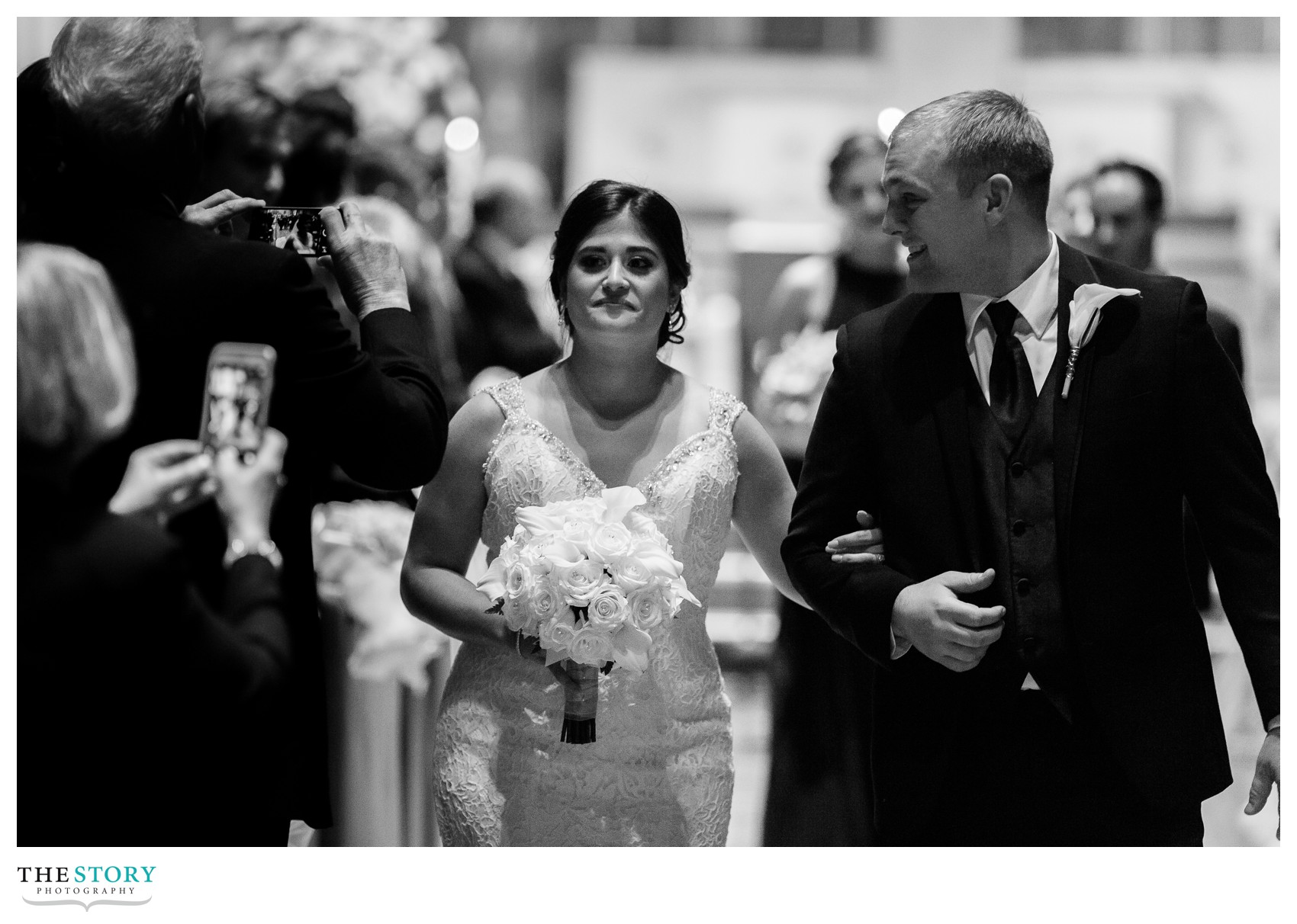 bride and groom walk aisle at syracuse cathedral wedding