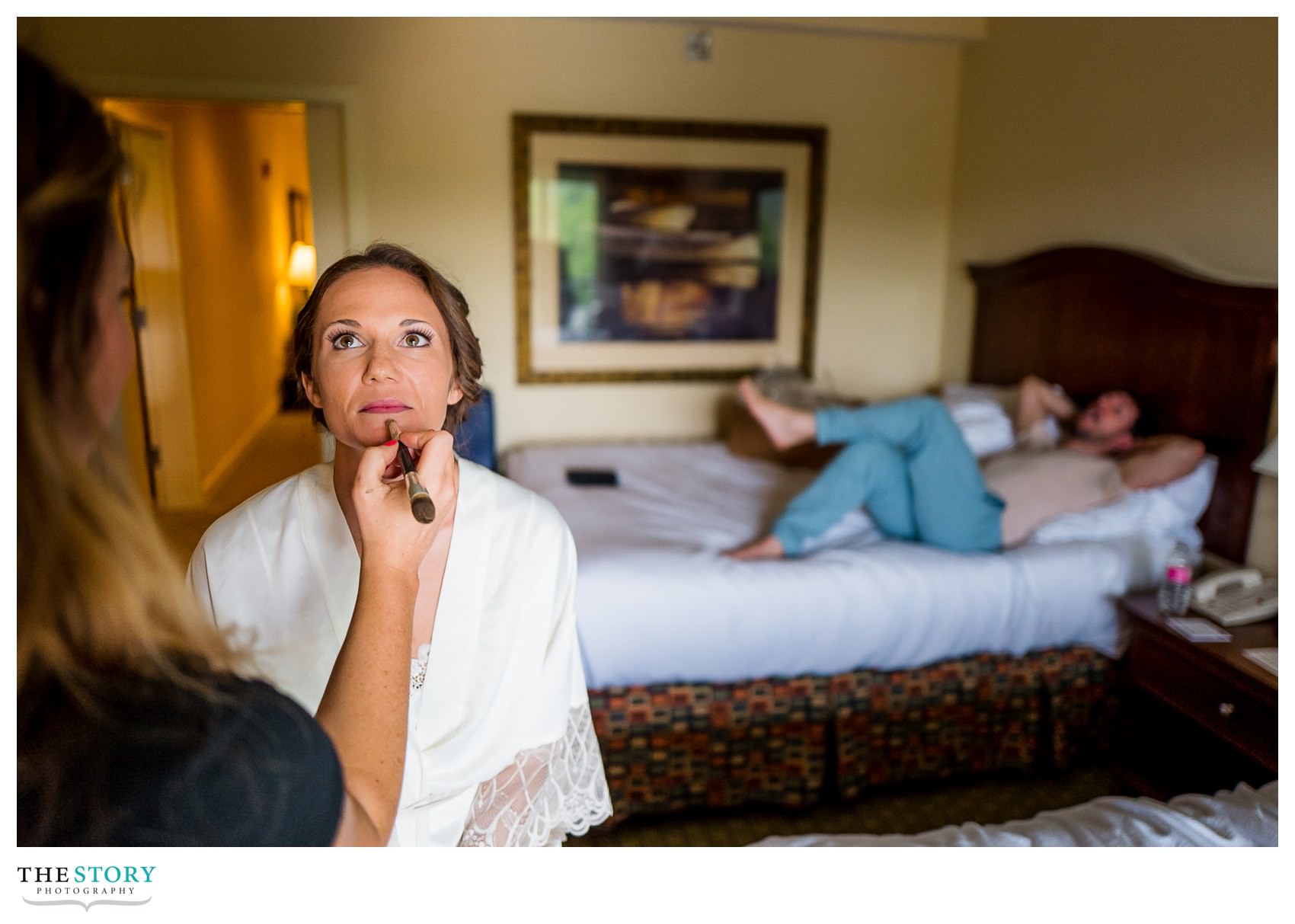 brother relaxes while bride gets ready for wedding day 