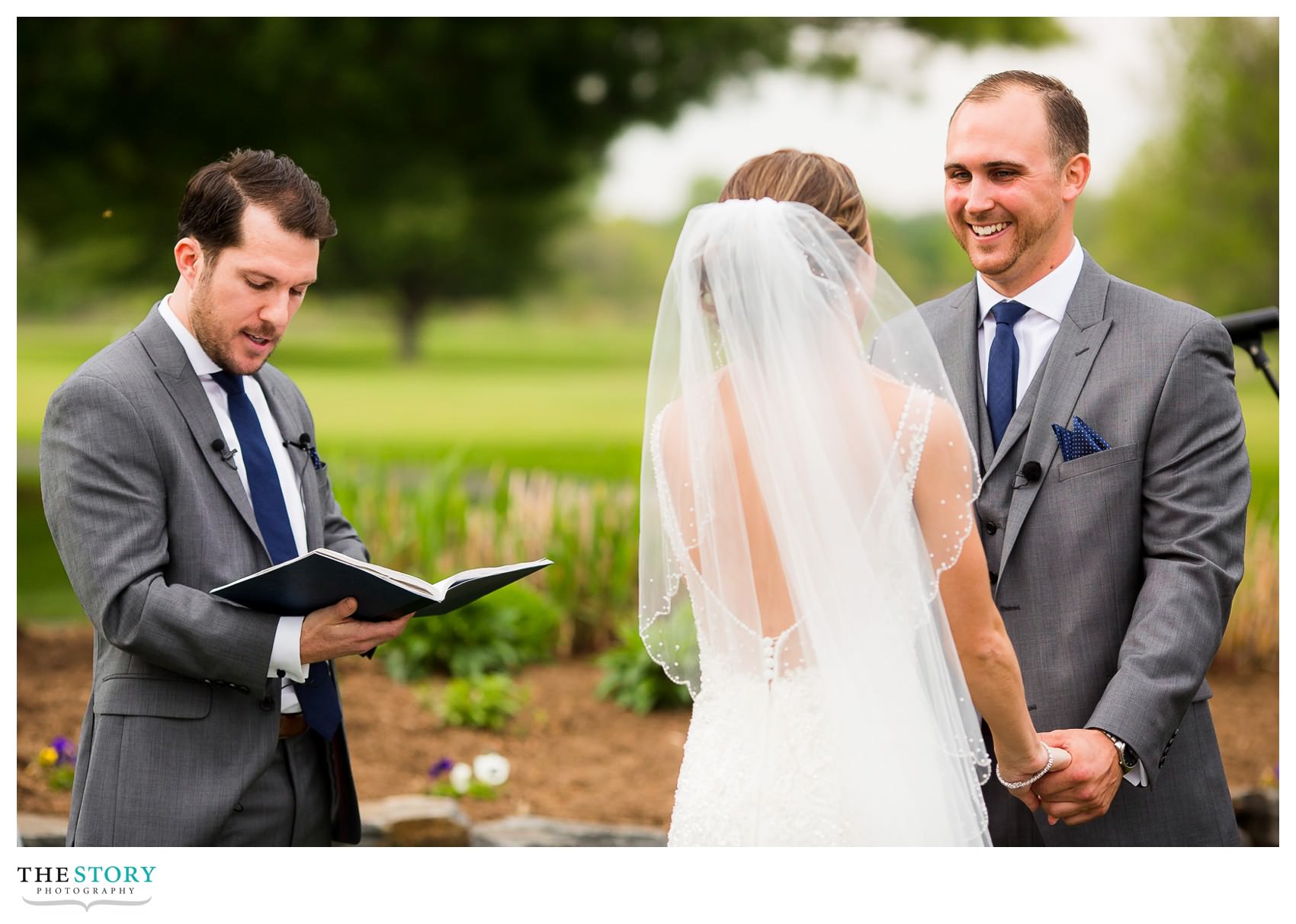 groom smiles at bride during Hiland Park wedding ceremony