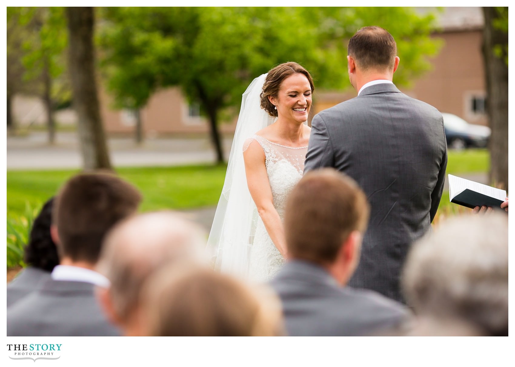 bride laughing during Queensbury, NY wedding ceremony