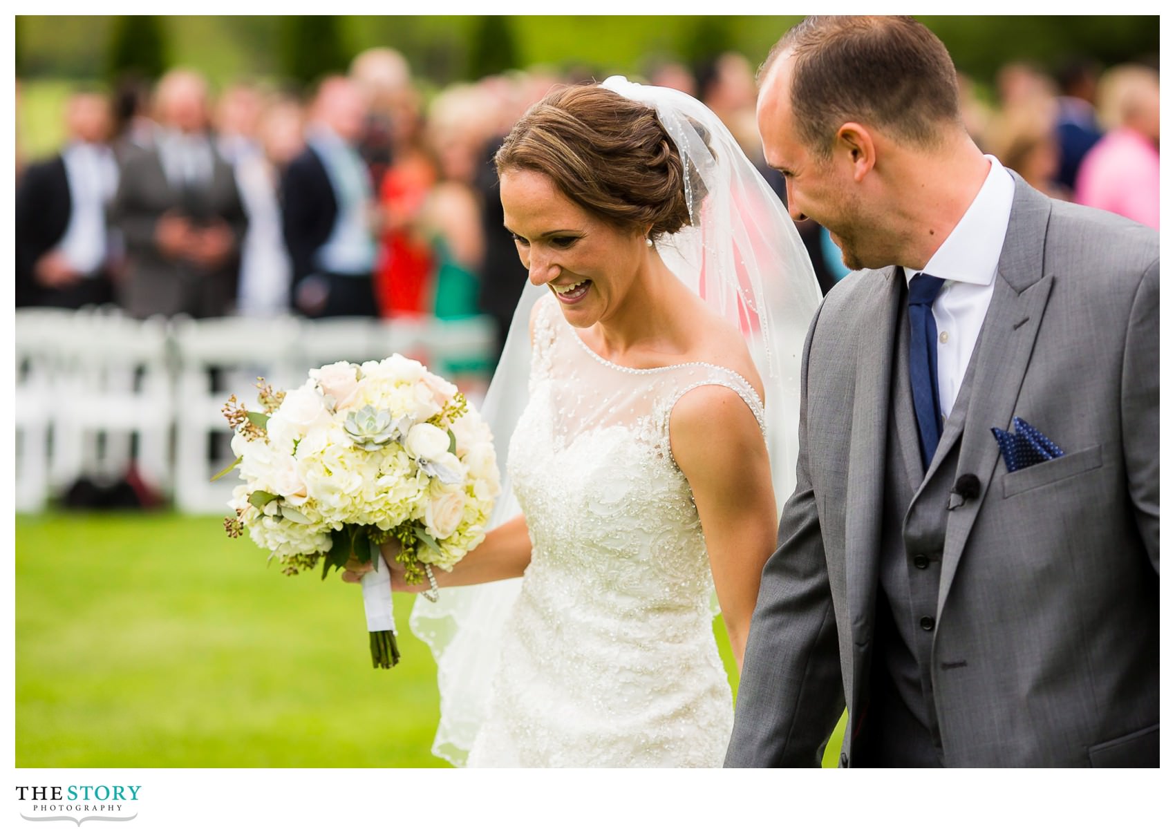 bride and groom enjoying their new marriage as they leave the ceremony