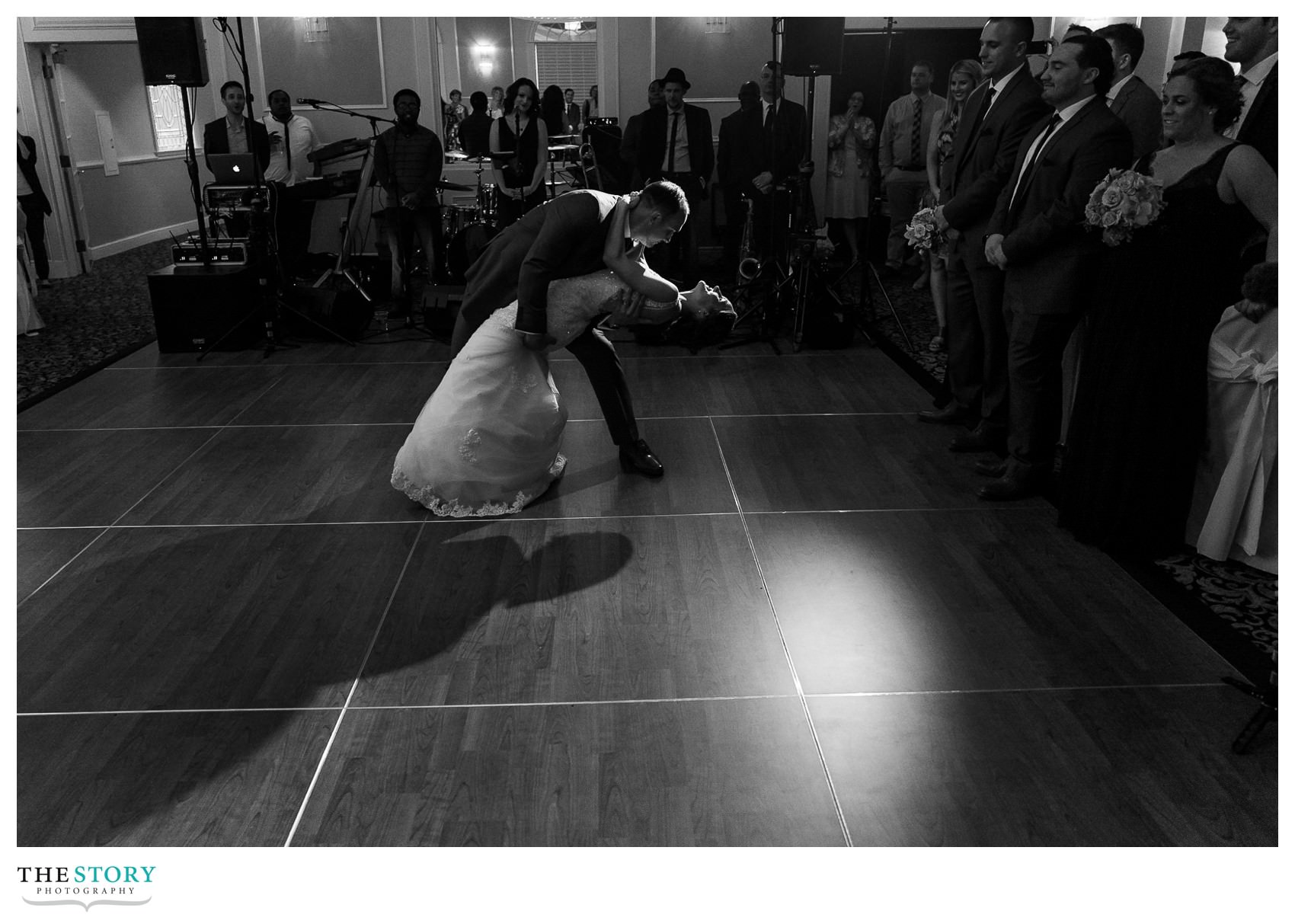 groom dips the bride during the first dance at their Hiland Park reception