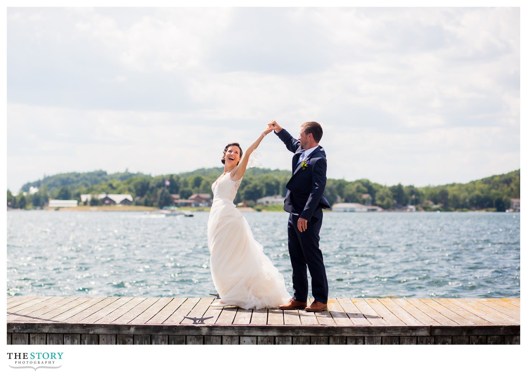 bride and groom dancing on the dock at Antique Boat Museum