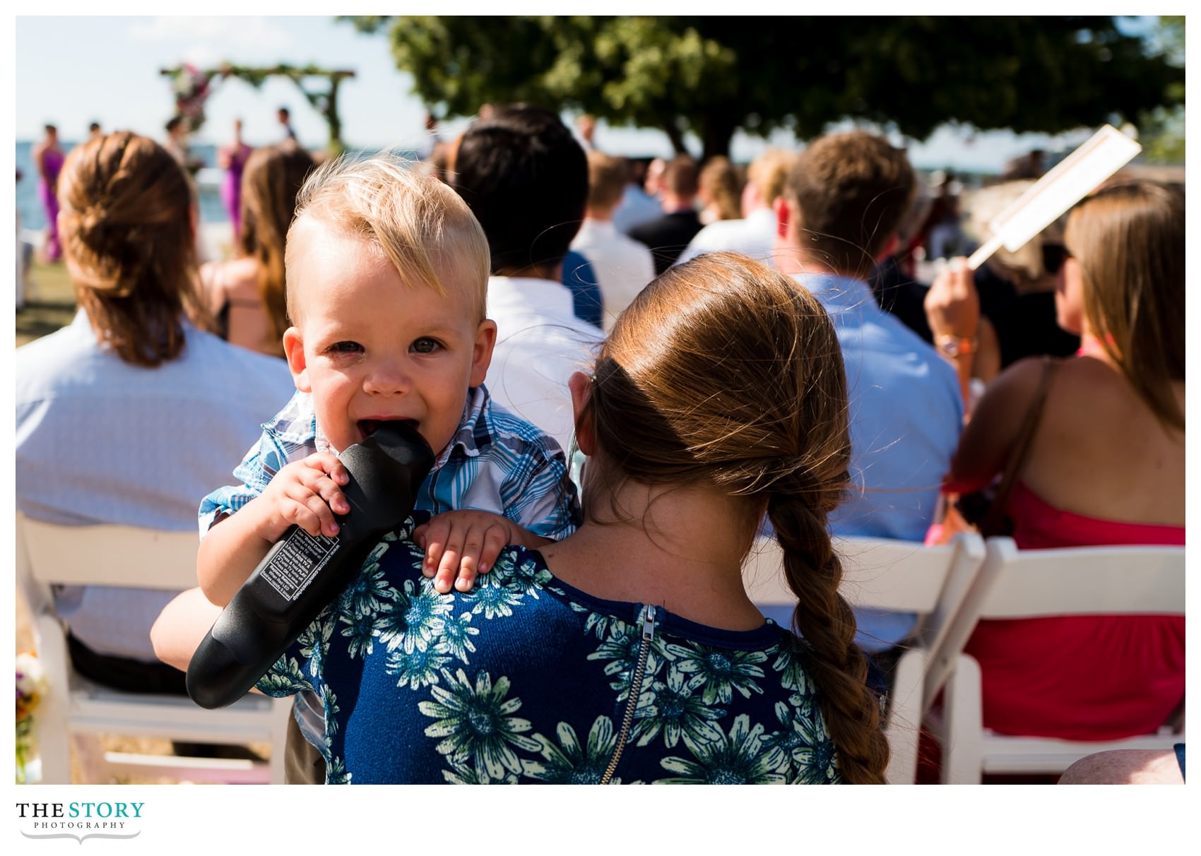 little boy at wedding ceremony at Antique Boat Museum