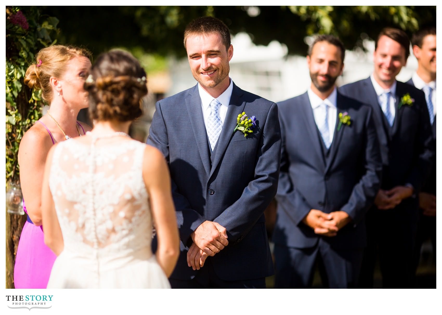 groom looking at bride during outdoor wedding ceremony at Antique Boat Museum