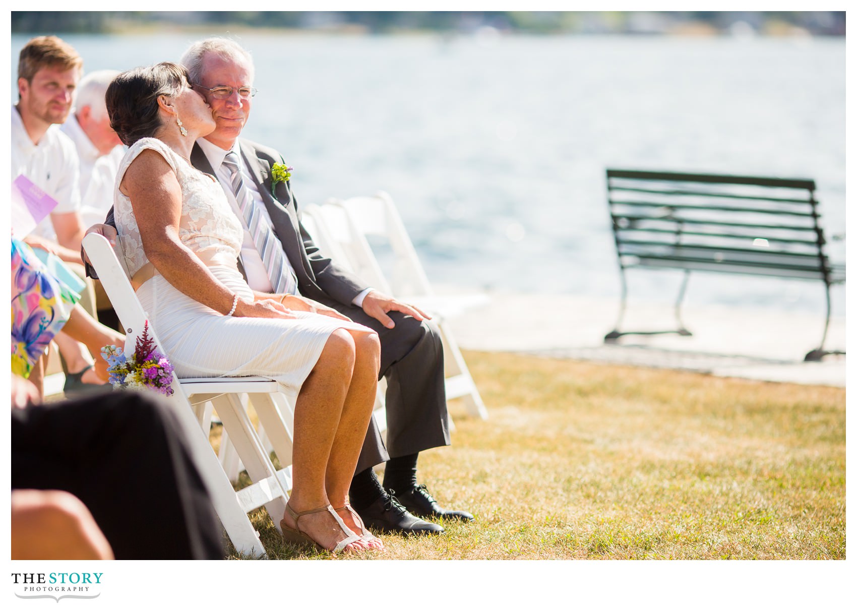 parents of the bride enjoy a little moment during the wedding ceremony