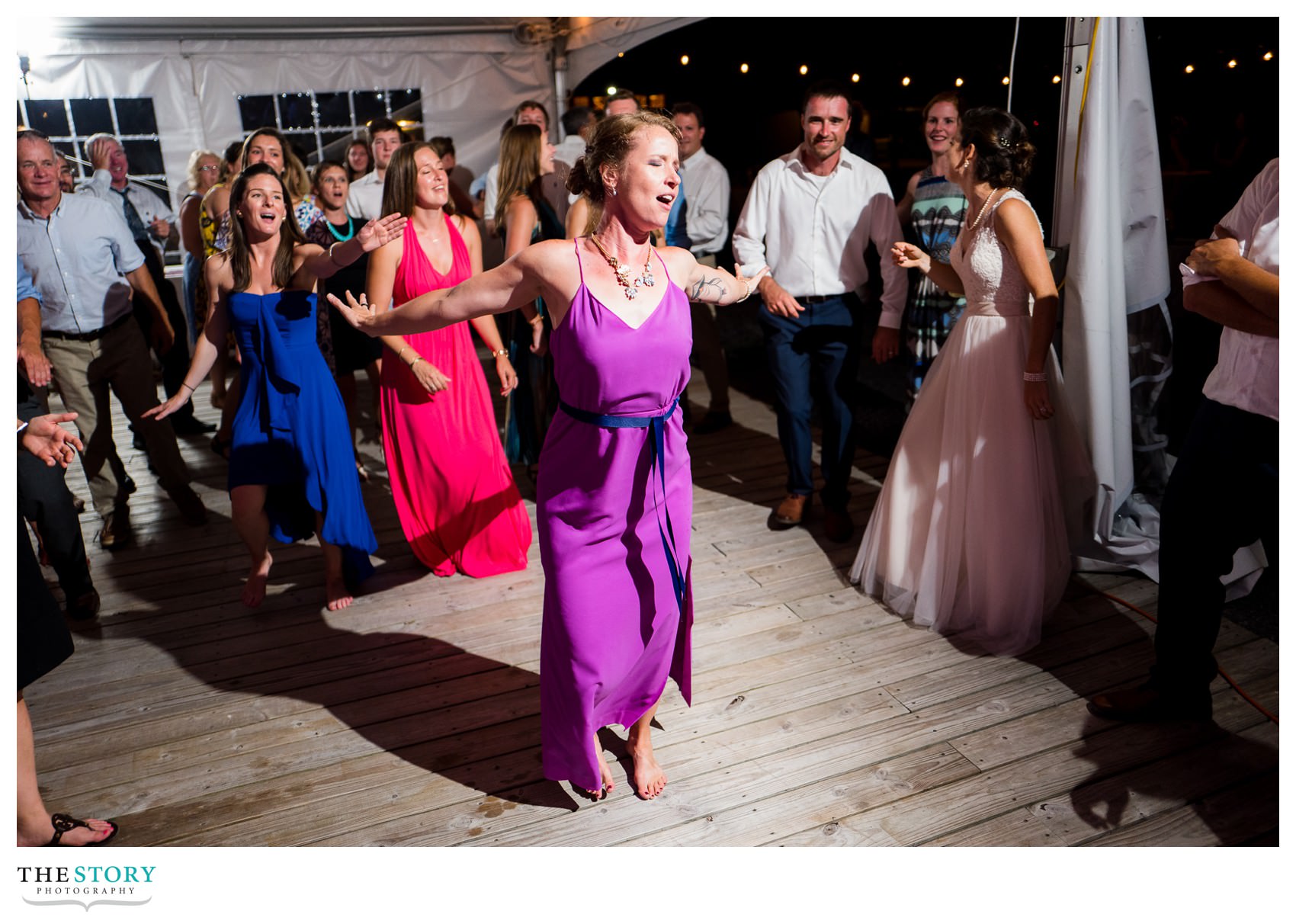 bridesmaid dancing at outdoor wedding reception in Clayton, NY