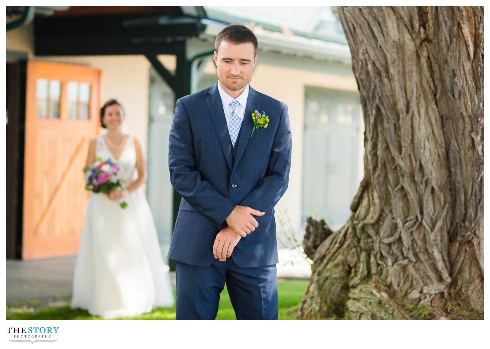 groom waiting to see bride during first look at Antique Boat Museum