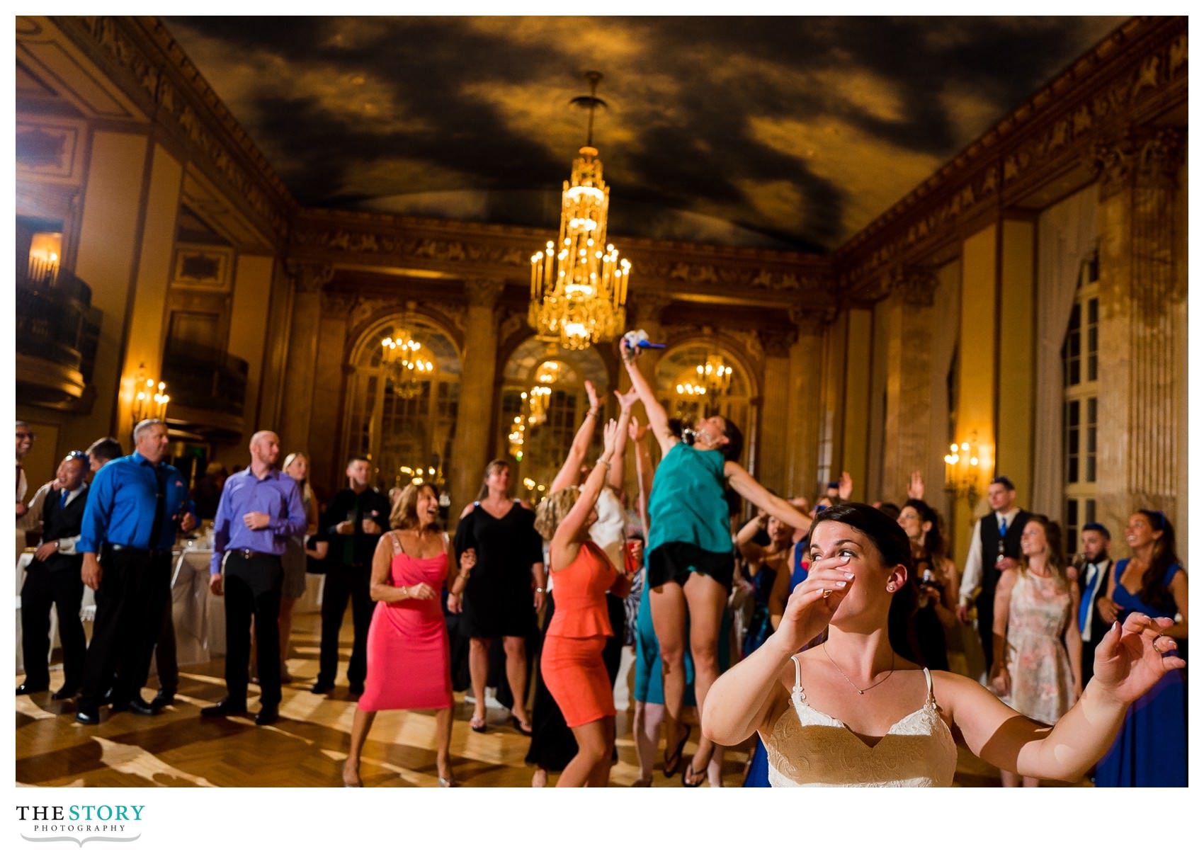 bride's bouquet toss at Marriott Syracuse Downtown wedding reception