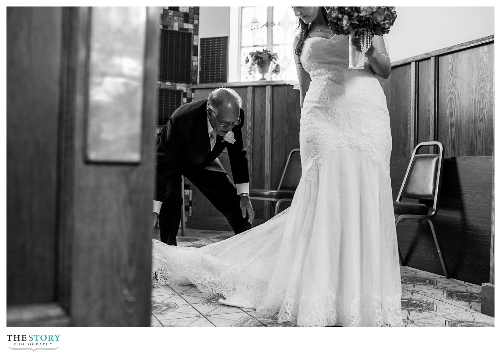 father helping bride with dress at Blessed Sacrament Church