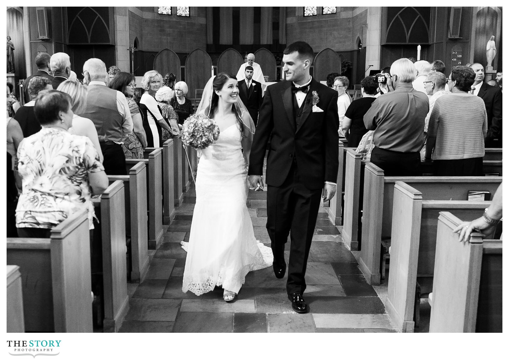 bride and groom walk down aisle at Syracuse Blessed Sacrament wedding