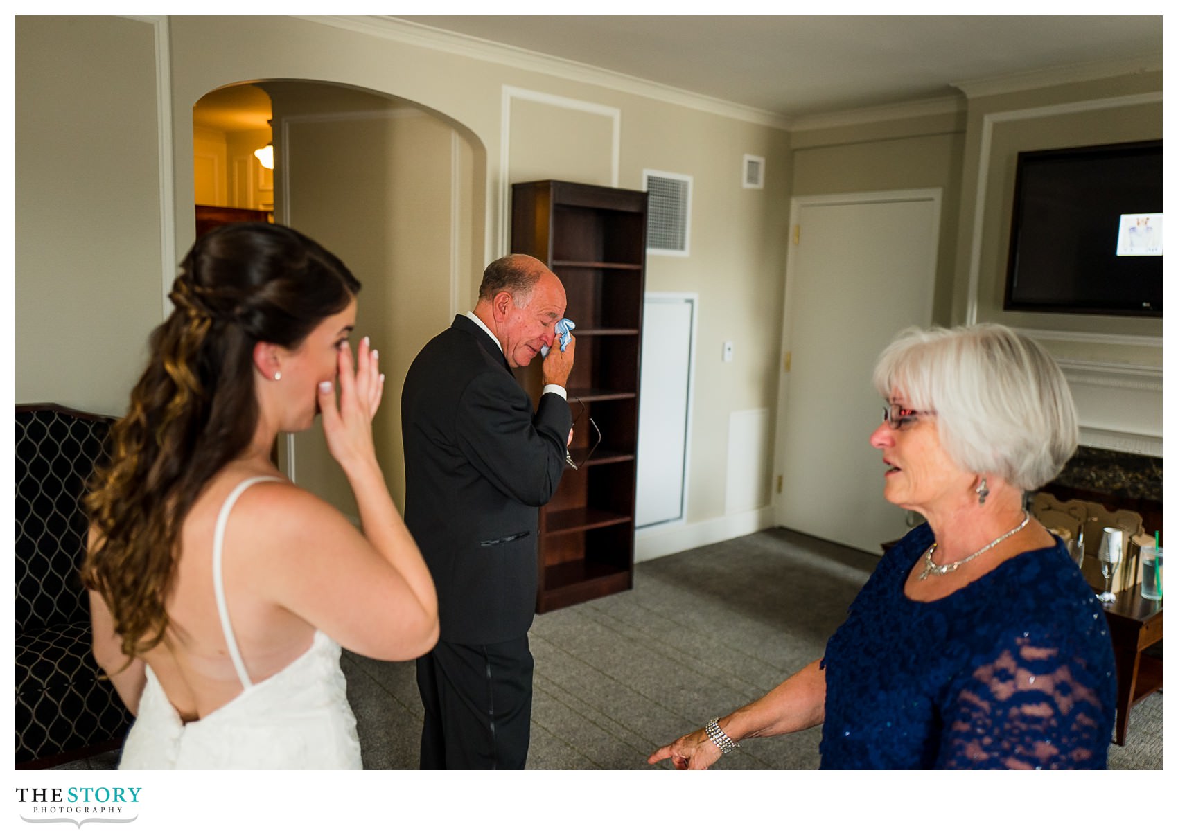 bride and father wipe tears together at Marriott Syracuse Downtown