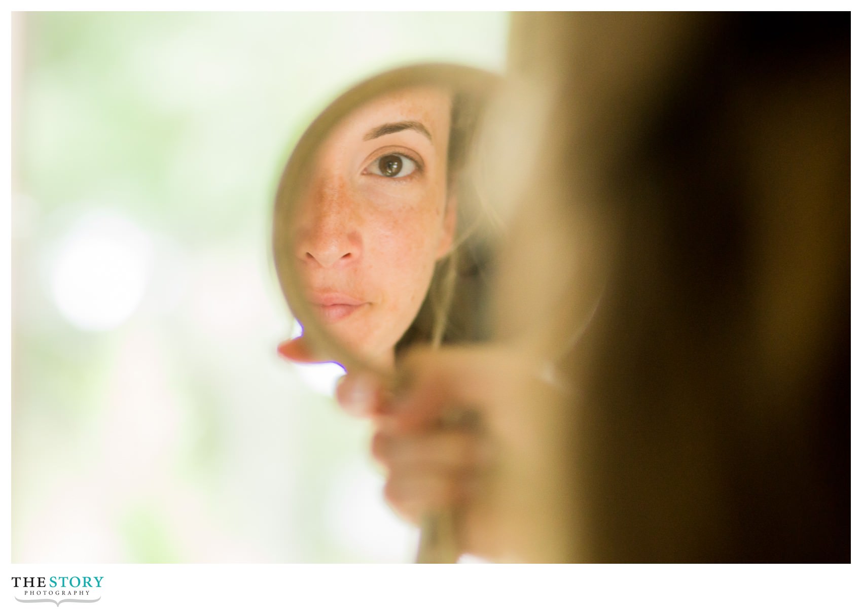 bride checking her makeup before Skaneateles Lake wedding