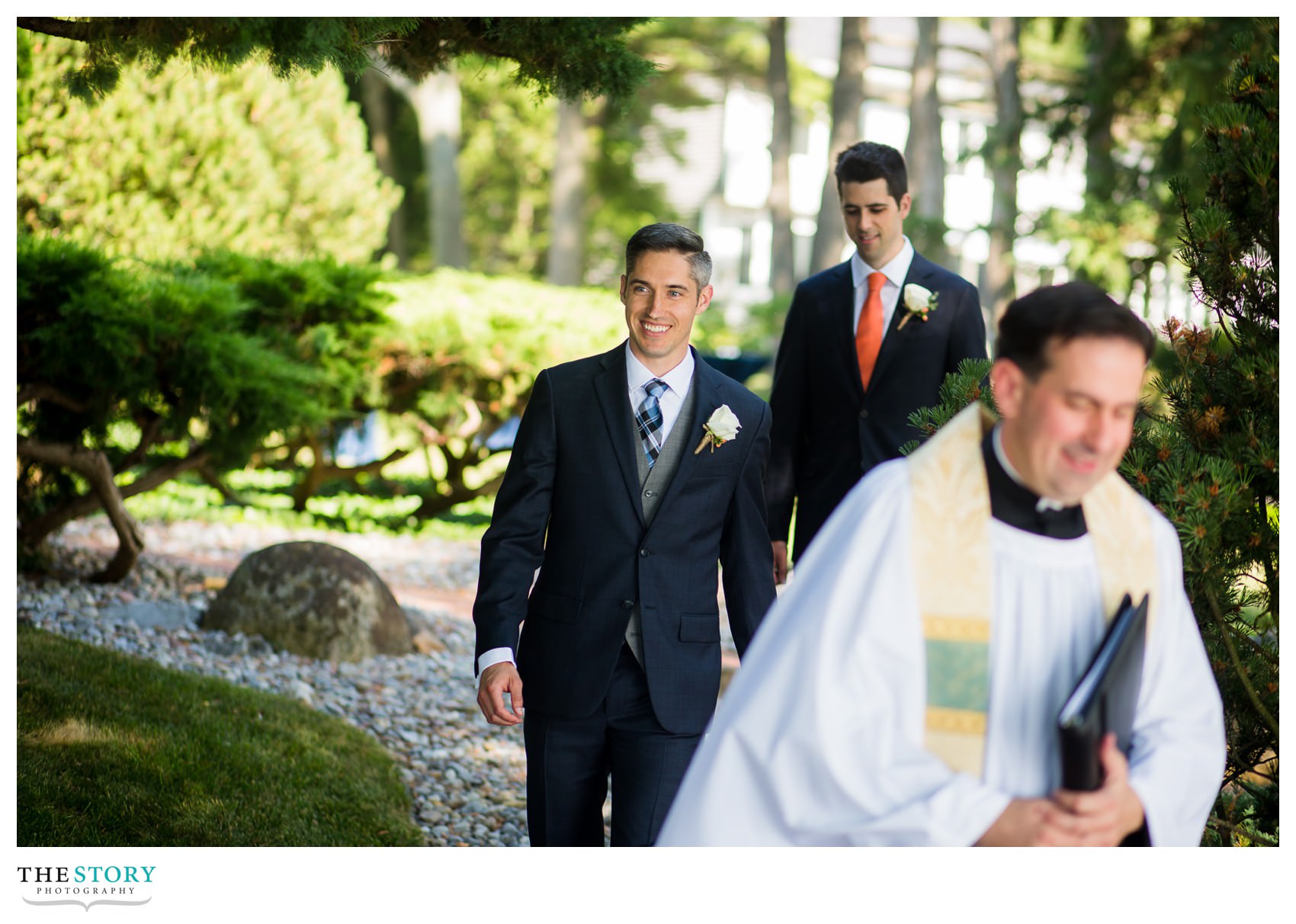 groom walks in to lakeside wedding ceremony on Skaneateles Lake