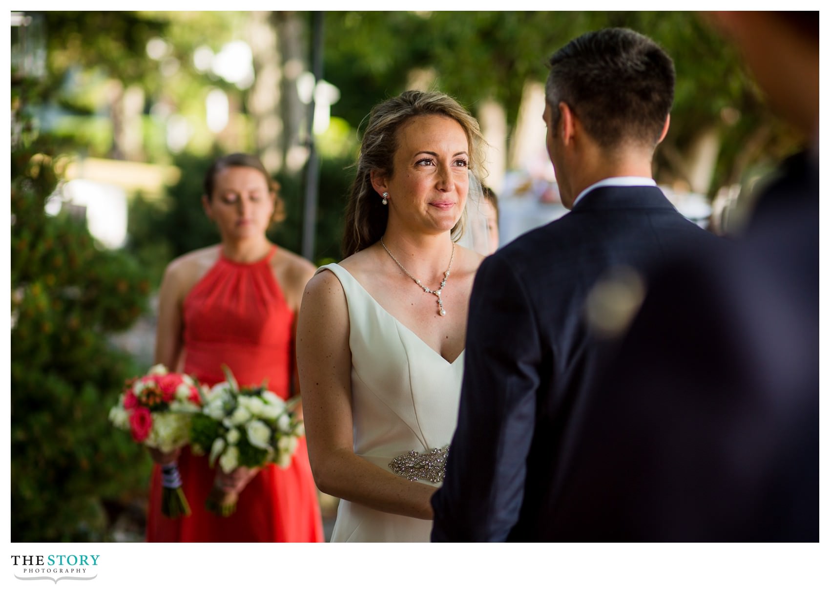 bride looks at groom during Skaneateles Lake wedding ceremony