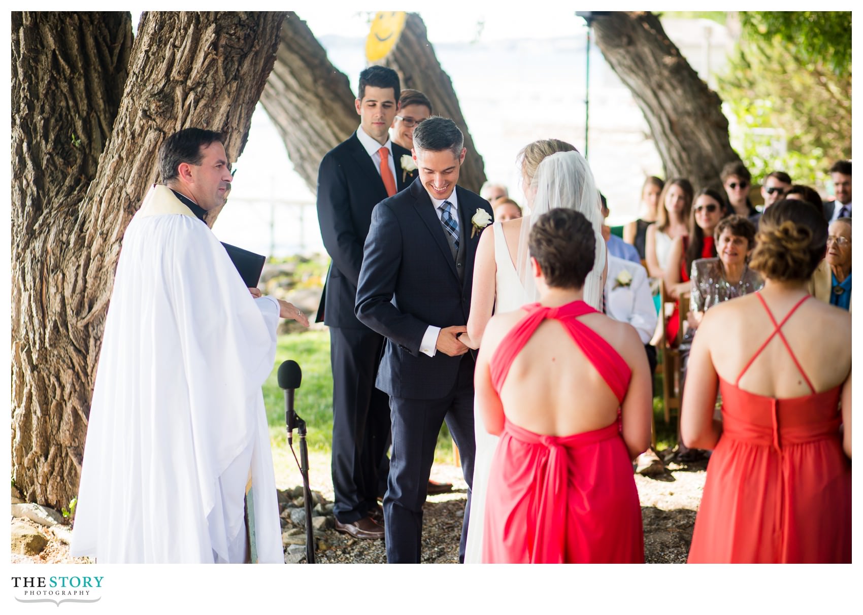 groom smiles during wedding ceremony 