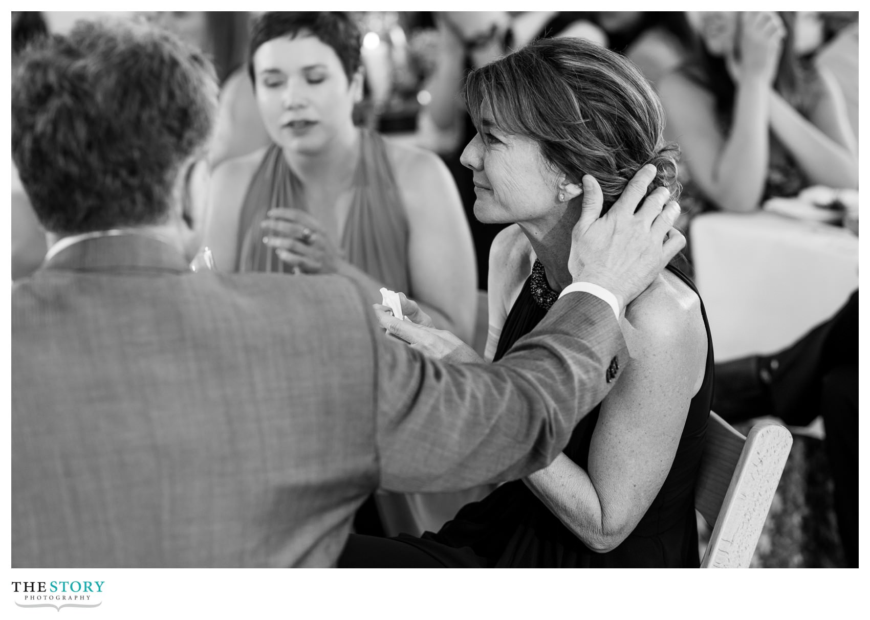 mother of the bride cries during first dance and is comforted by her husband