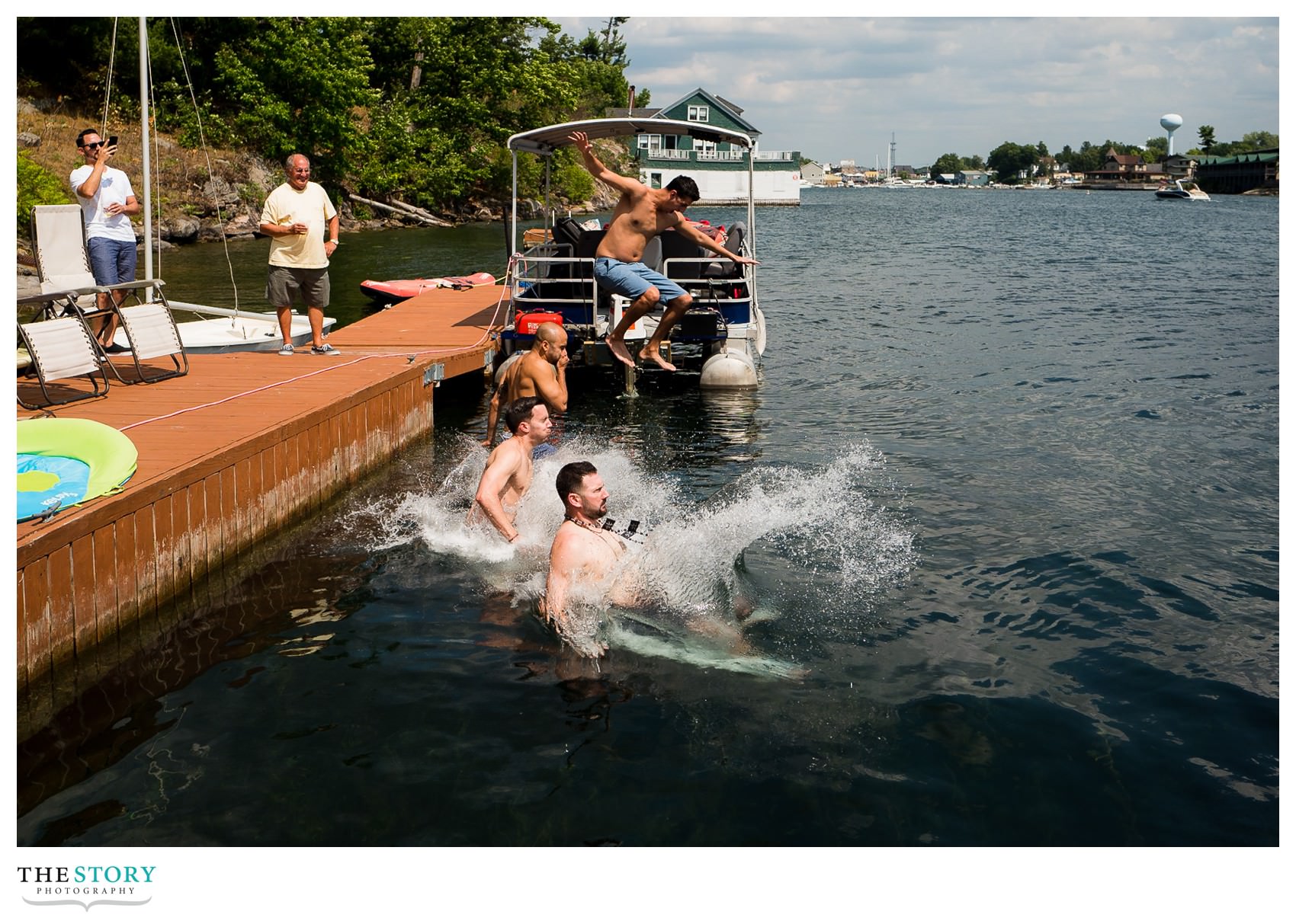 groomsmen get ready for thousand islands wedding with swim in the river