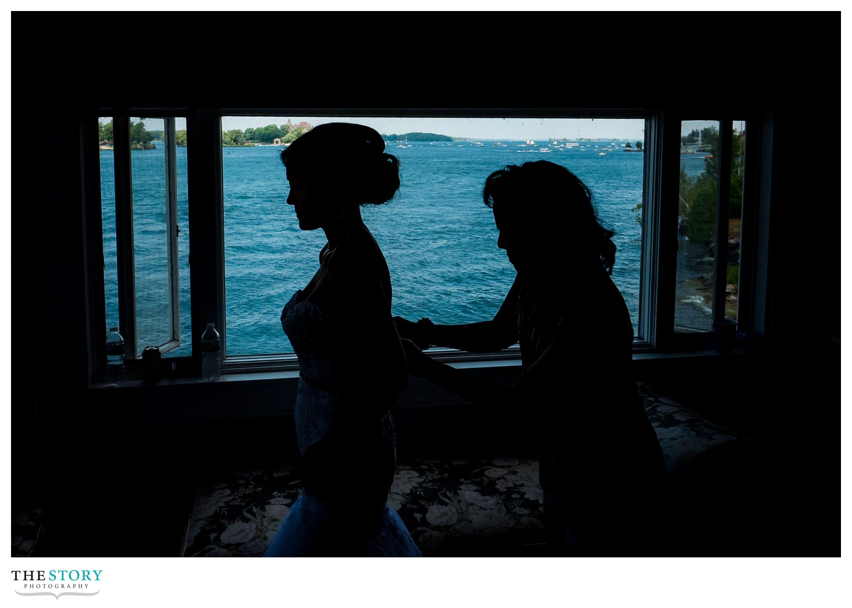 bride gets dress on for Thousand Islands river wedding on Cherry Island