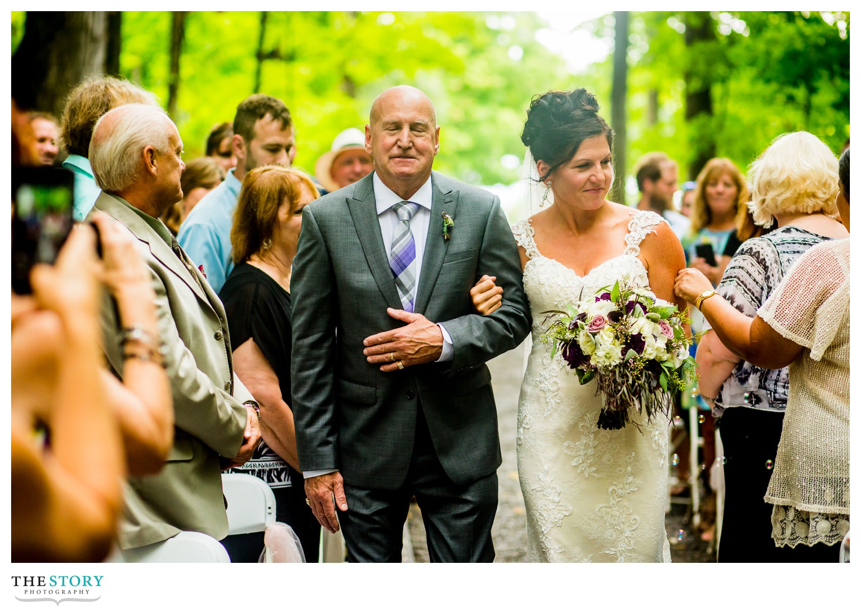 bride walks down aisle with her father at outdoor Ithaca wedding ceremony