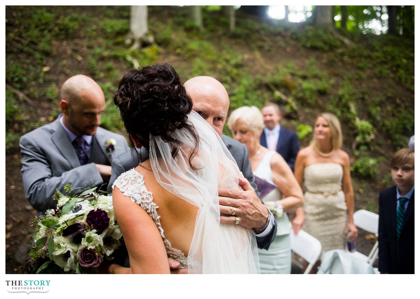 father hugs bride on wedding day at New Park