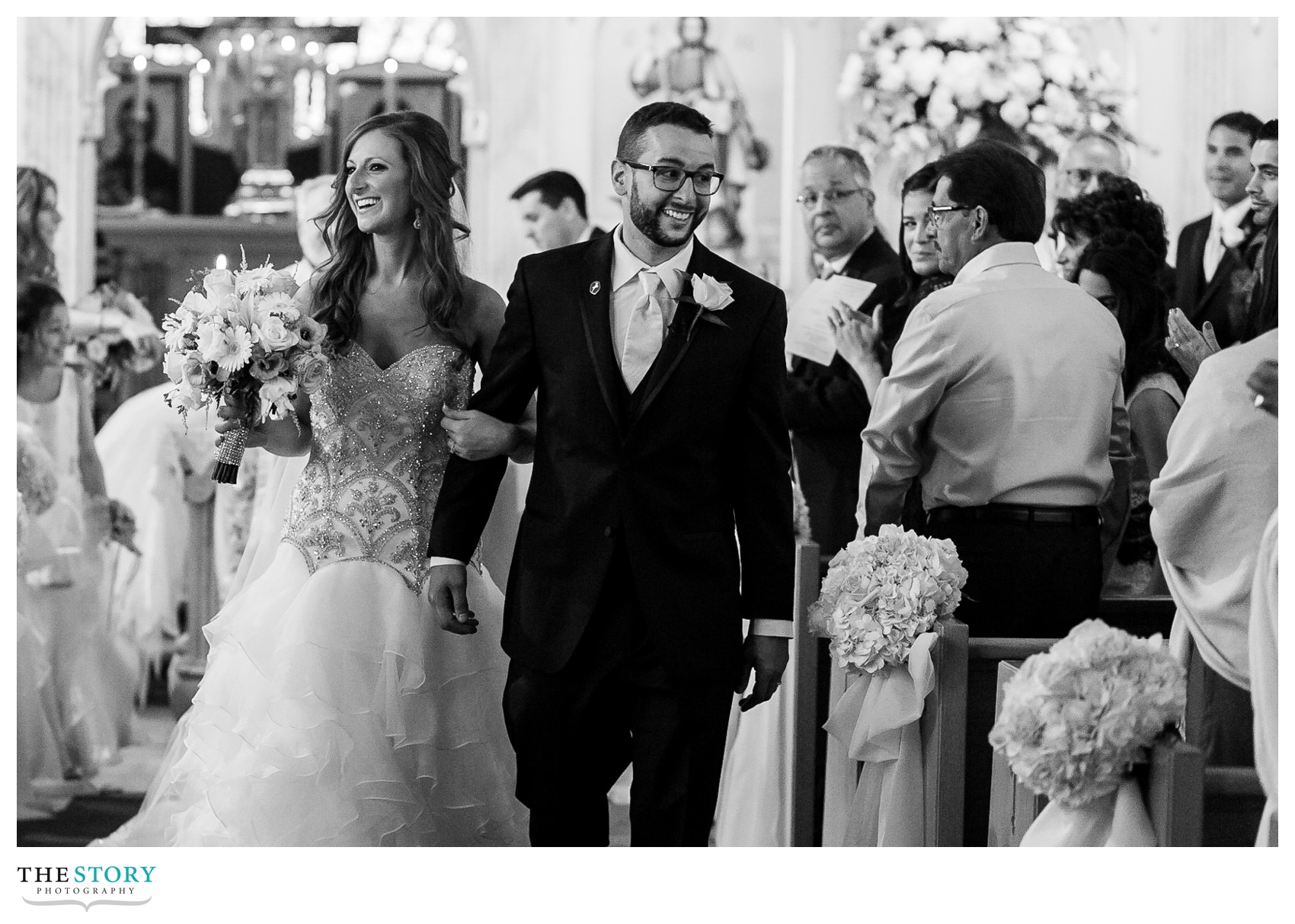 bride and groom walk aisle at St. Micheal's wedding ceremony