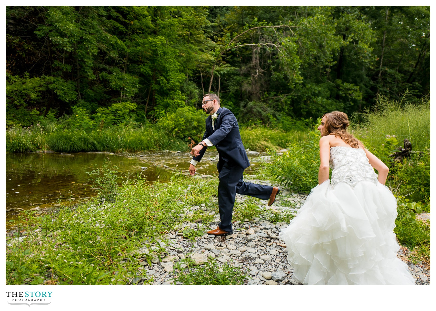 bride and groom skipping stones at Glenora Falls