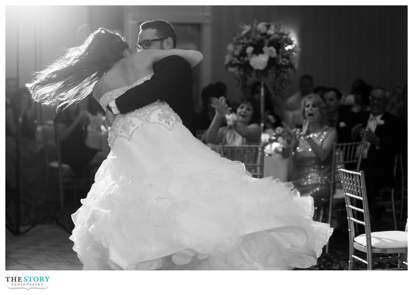 groom picks up bride during first dance