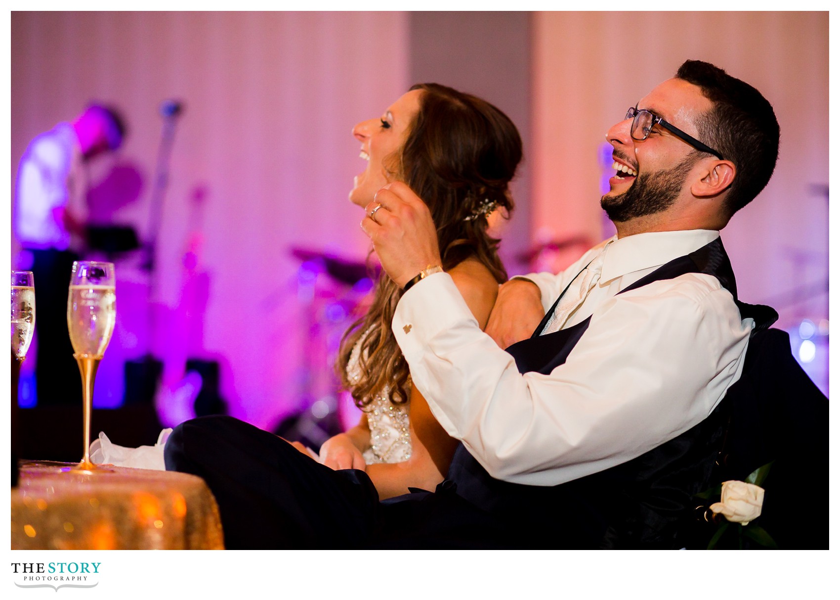 bride and groom react to speeches at wedding reception
