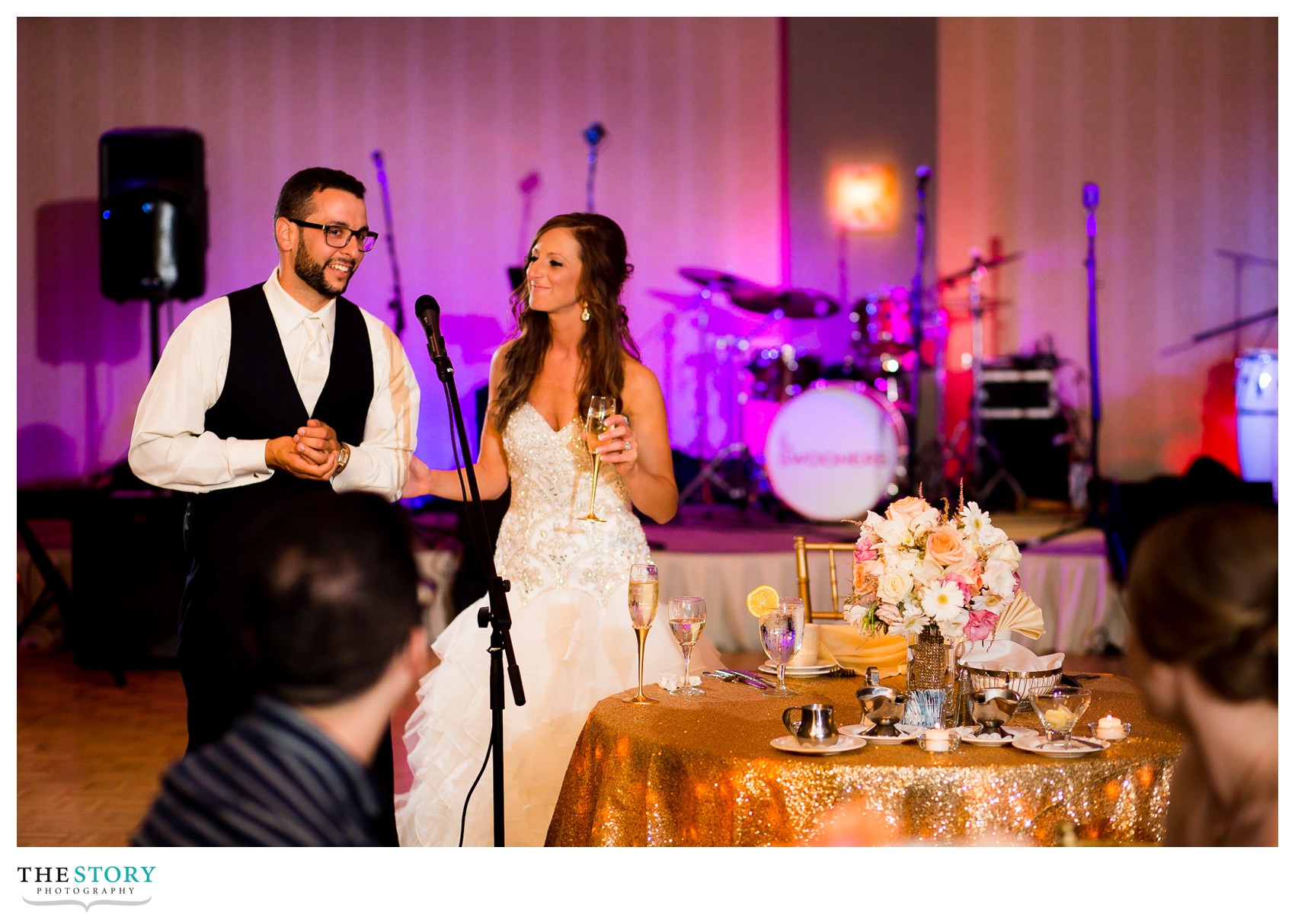 bride and groom say a few words to thank guests at wedding reception