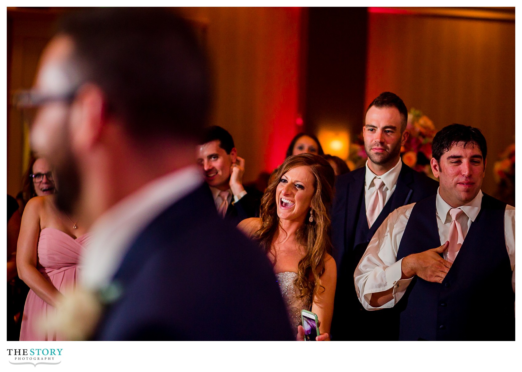 bride enjoys watching groom and mother dance