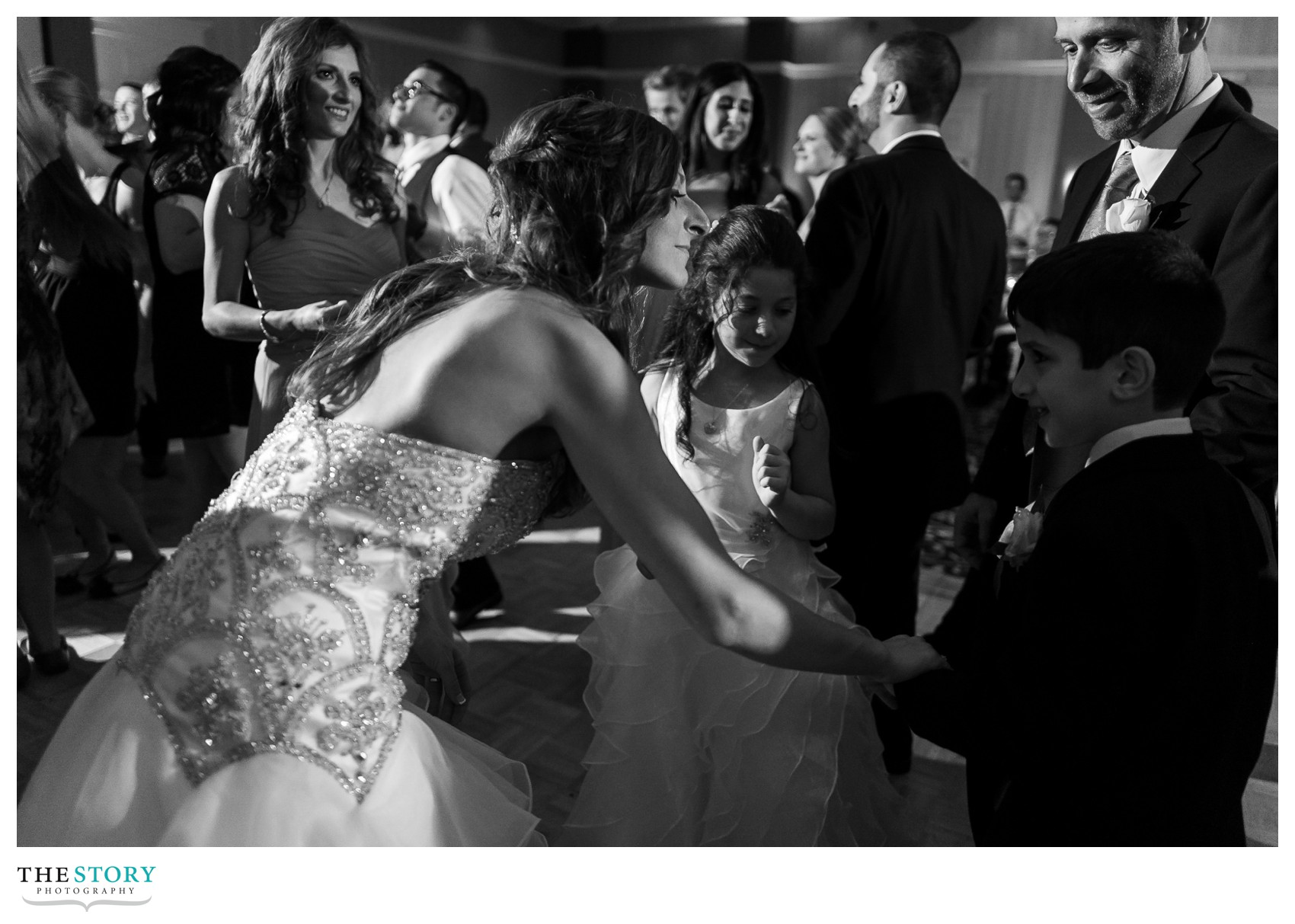 bride dances with kids at wedding reception