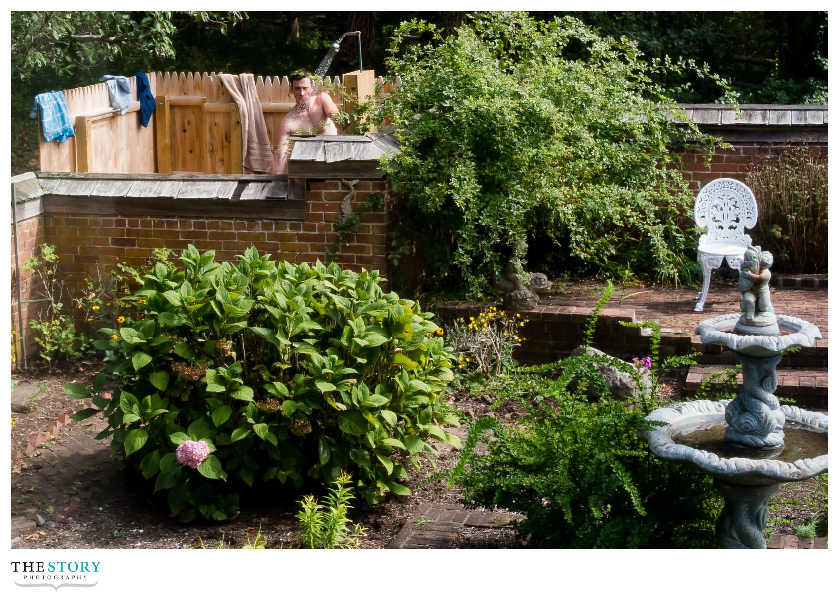 groomsman takes outdoor shower at Cape Cod wedding