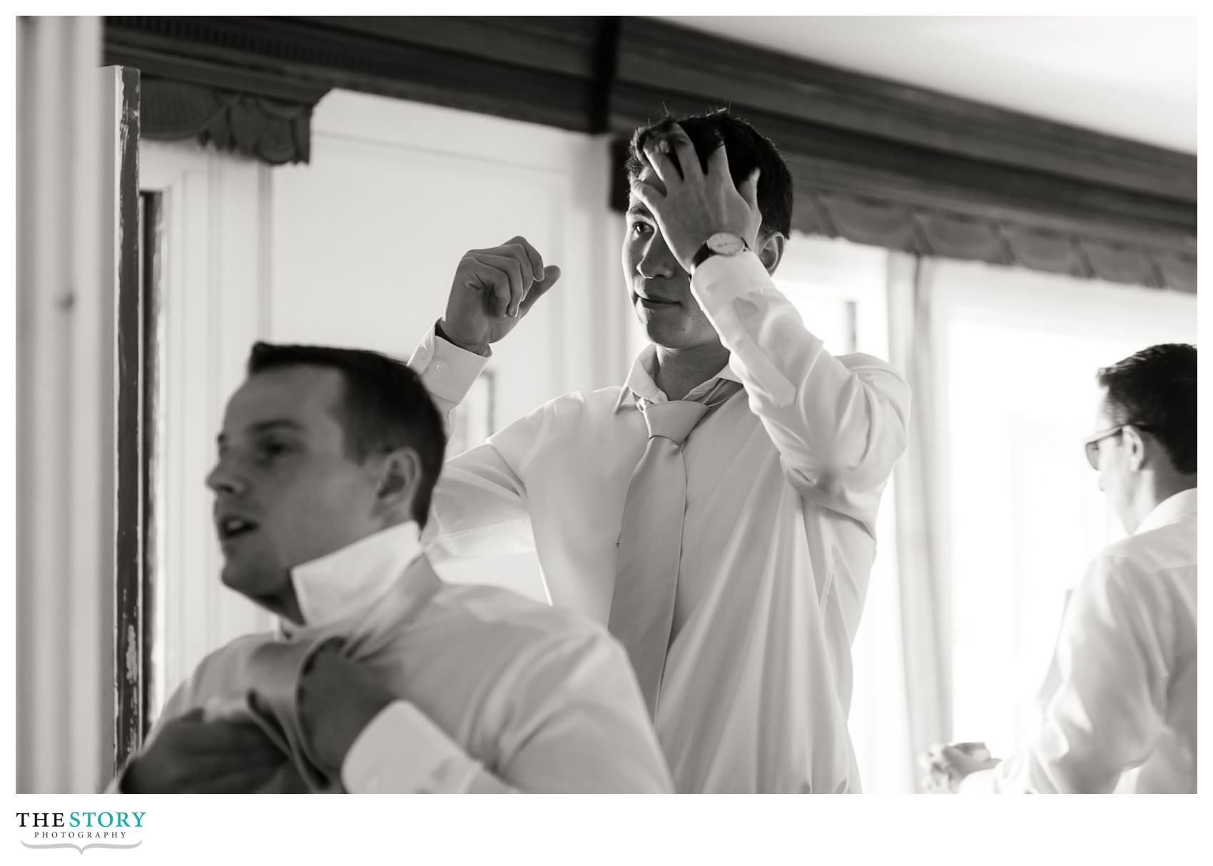 Groom gets ready with his guys before Cape Cod wedding.