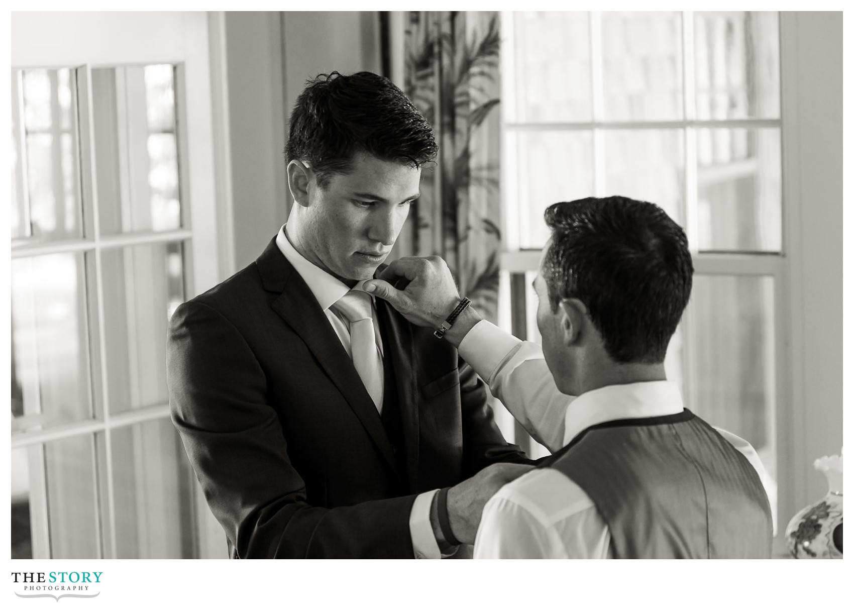 groom getting ready with groomsman before wedding ceremony