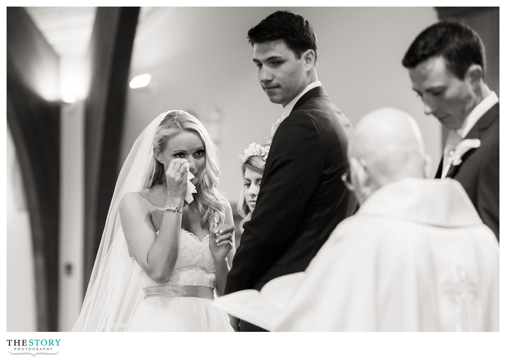 bride wipes a tear during wedding ceremony in Brewster, MA