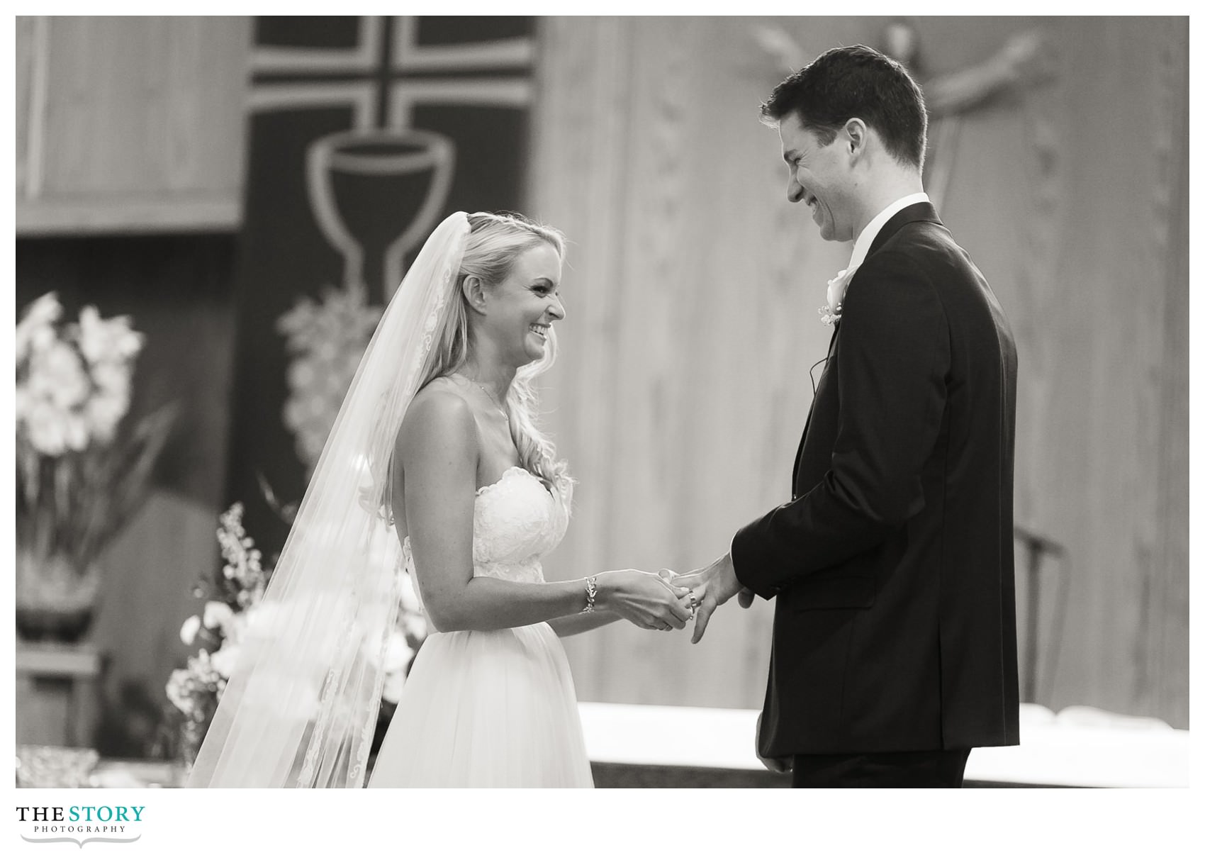 bride places ring on groom's finger during Cape Cod wedding ceremony